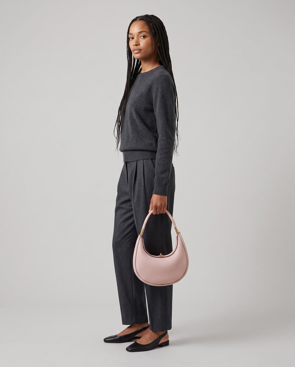Model wearing the Todi crescent bag in Blush – full-length view