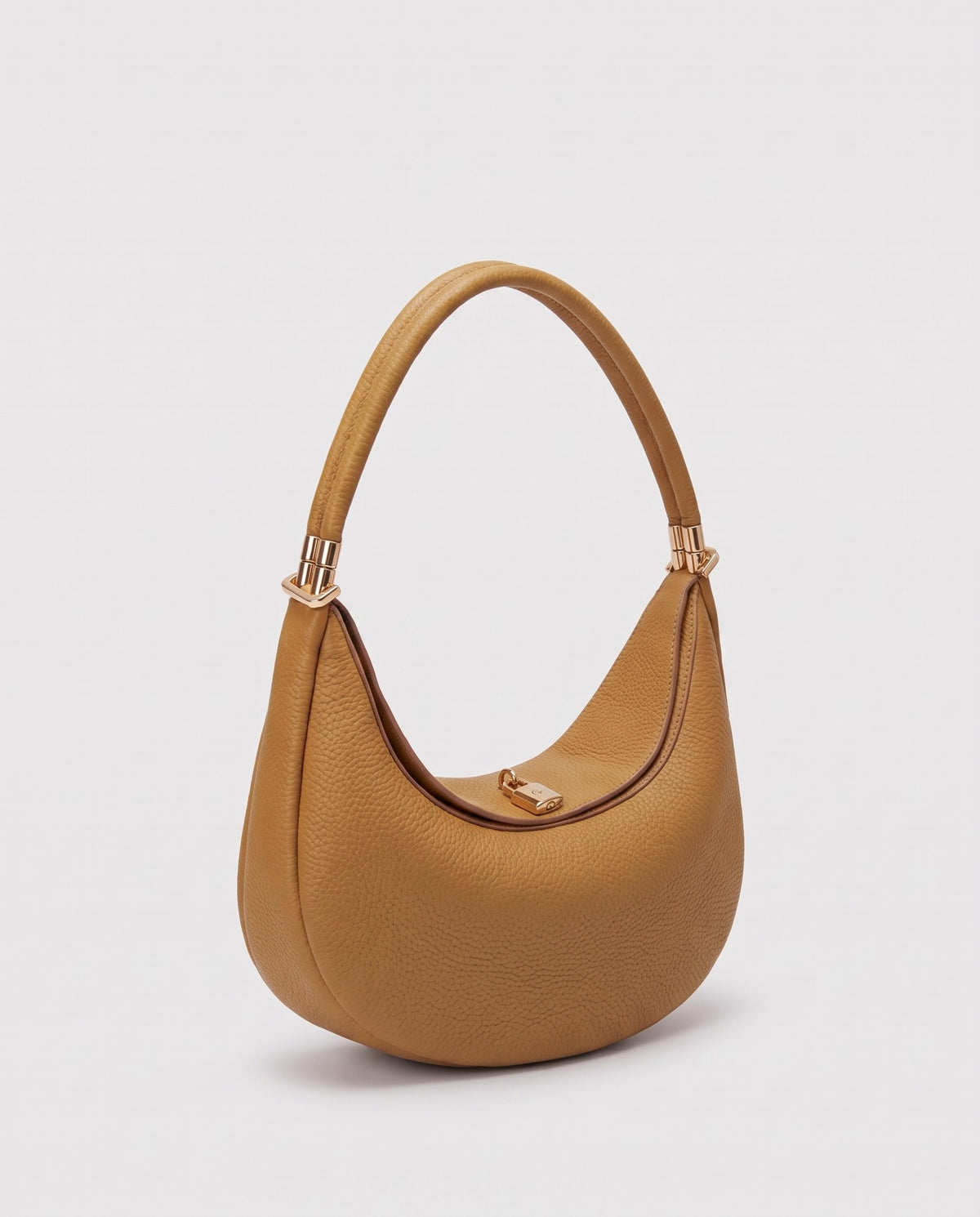 Todi pebbled leather crescent bag in Caramel – three-quarter view