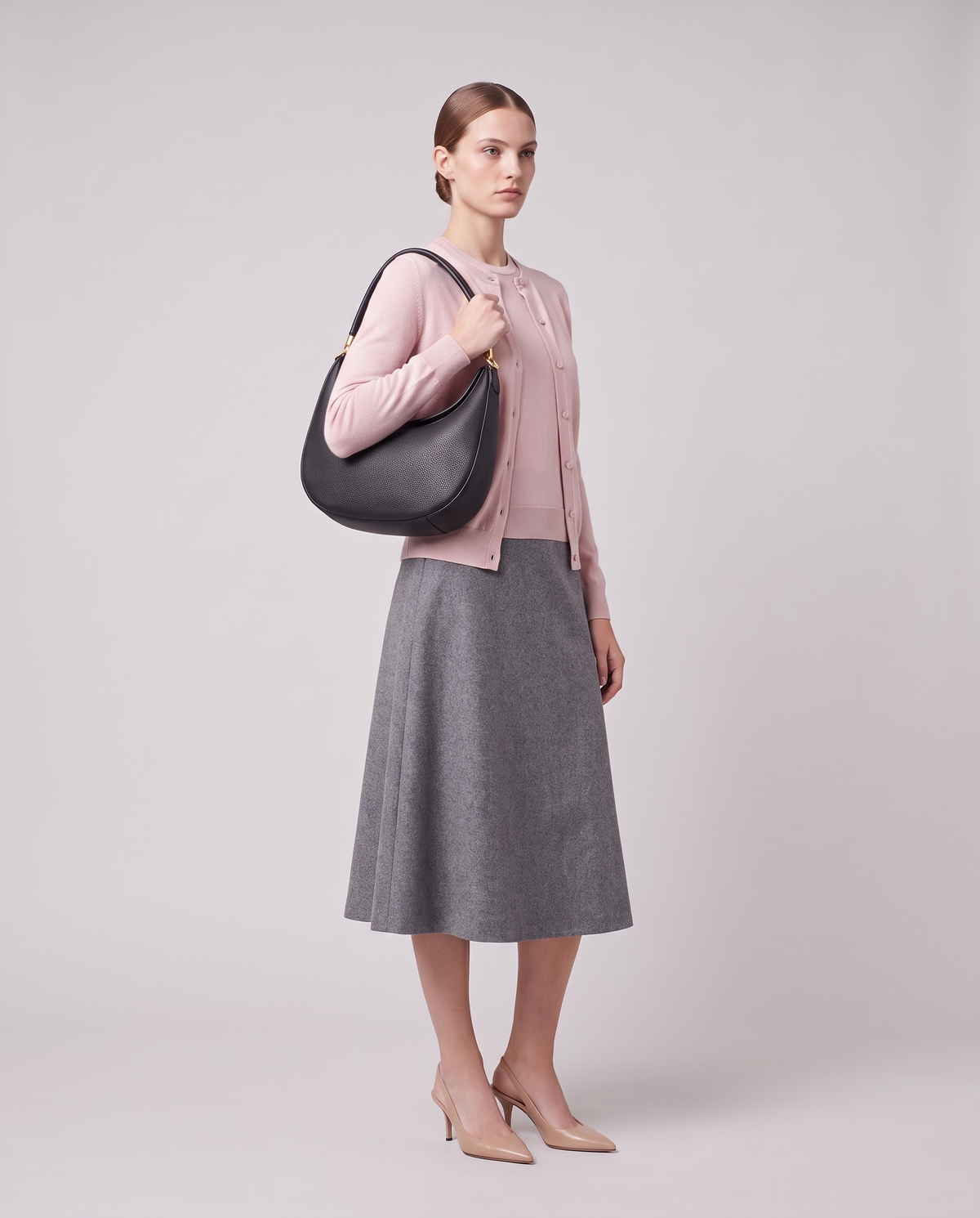 Model carrying the Todi crescent bag in Black