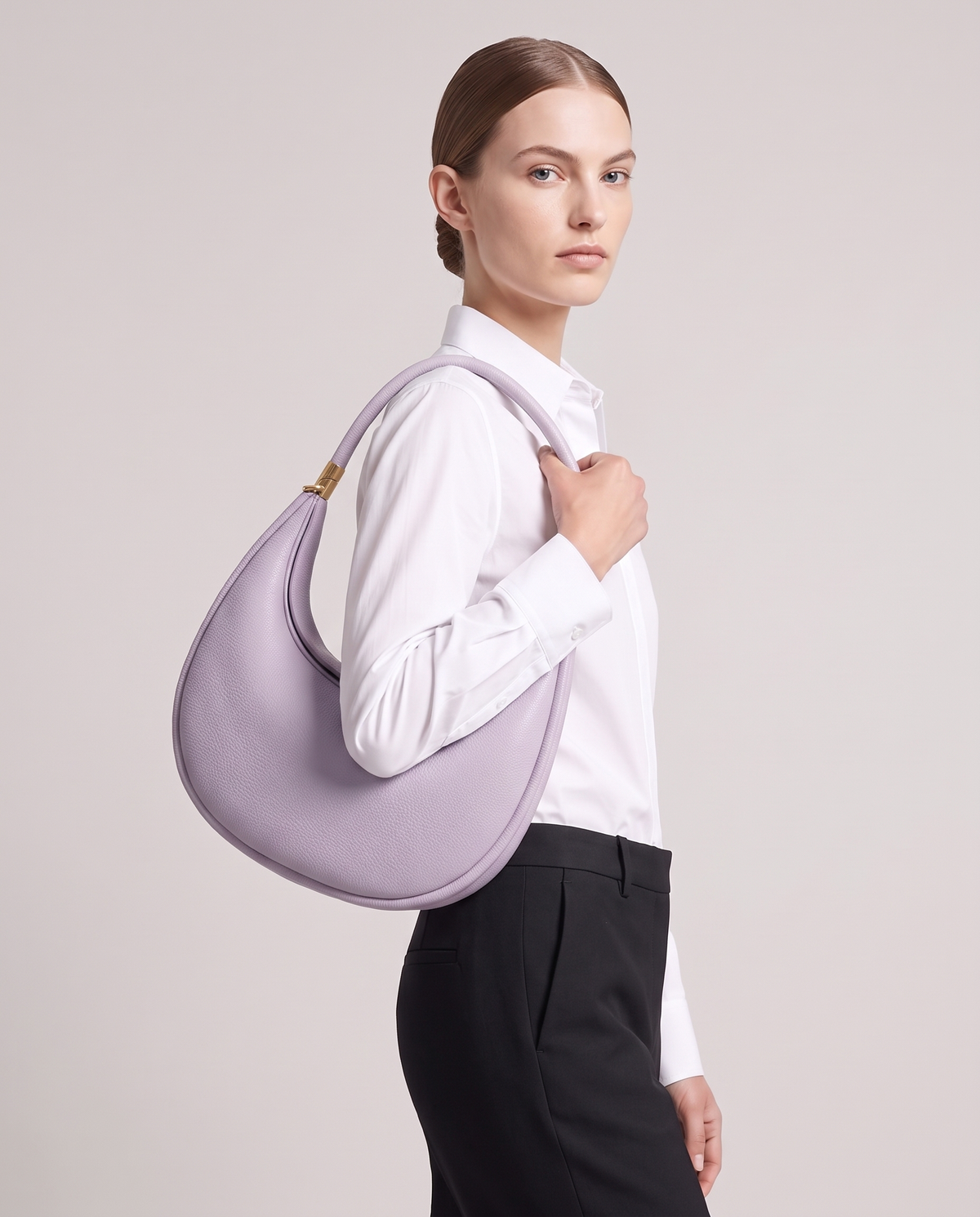 Model carrying the Todi crescent bag in Caramel