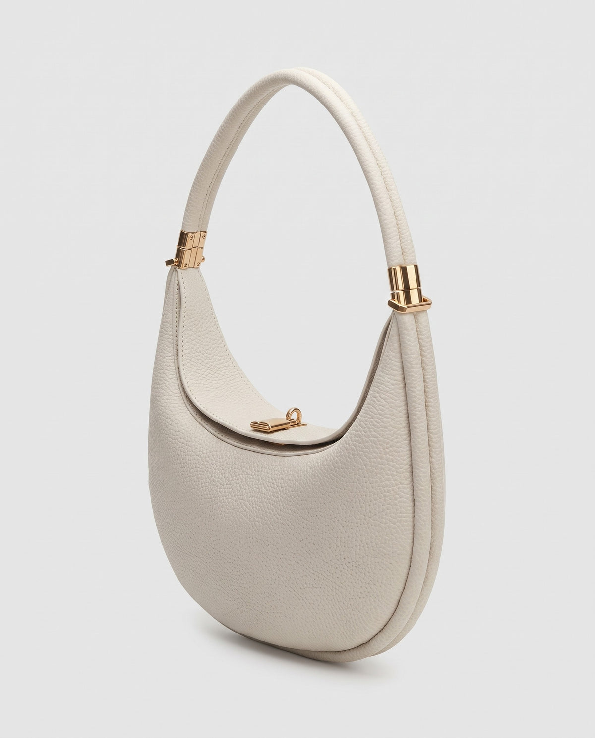 Todi pebbled leather crescent bag in Ivory – three-quarter view
