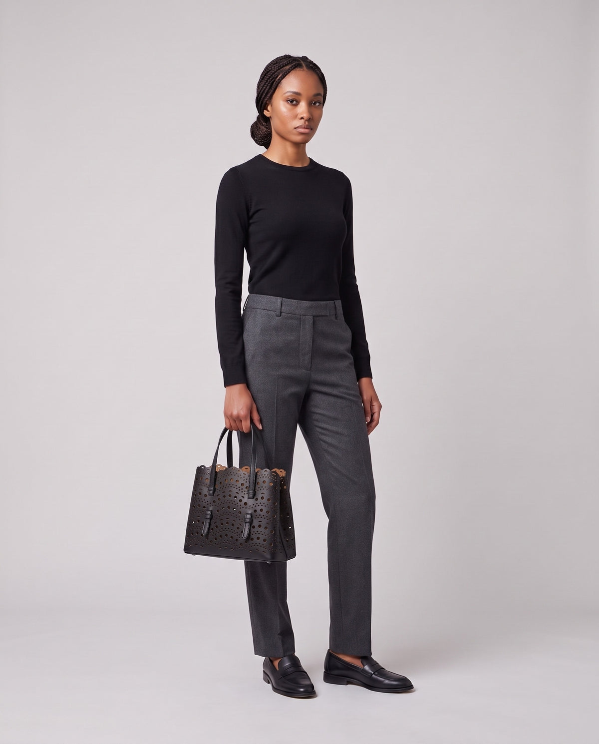Model holding the Valentina Urbino Large bag in Black, full length