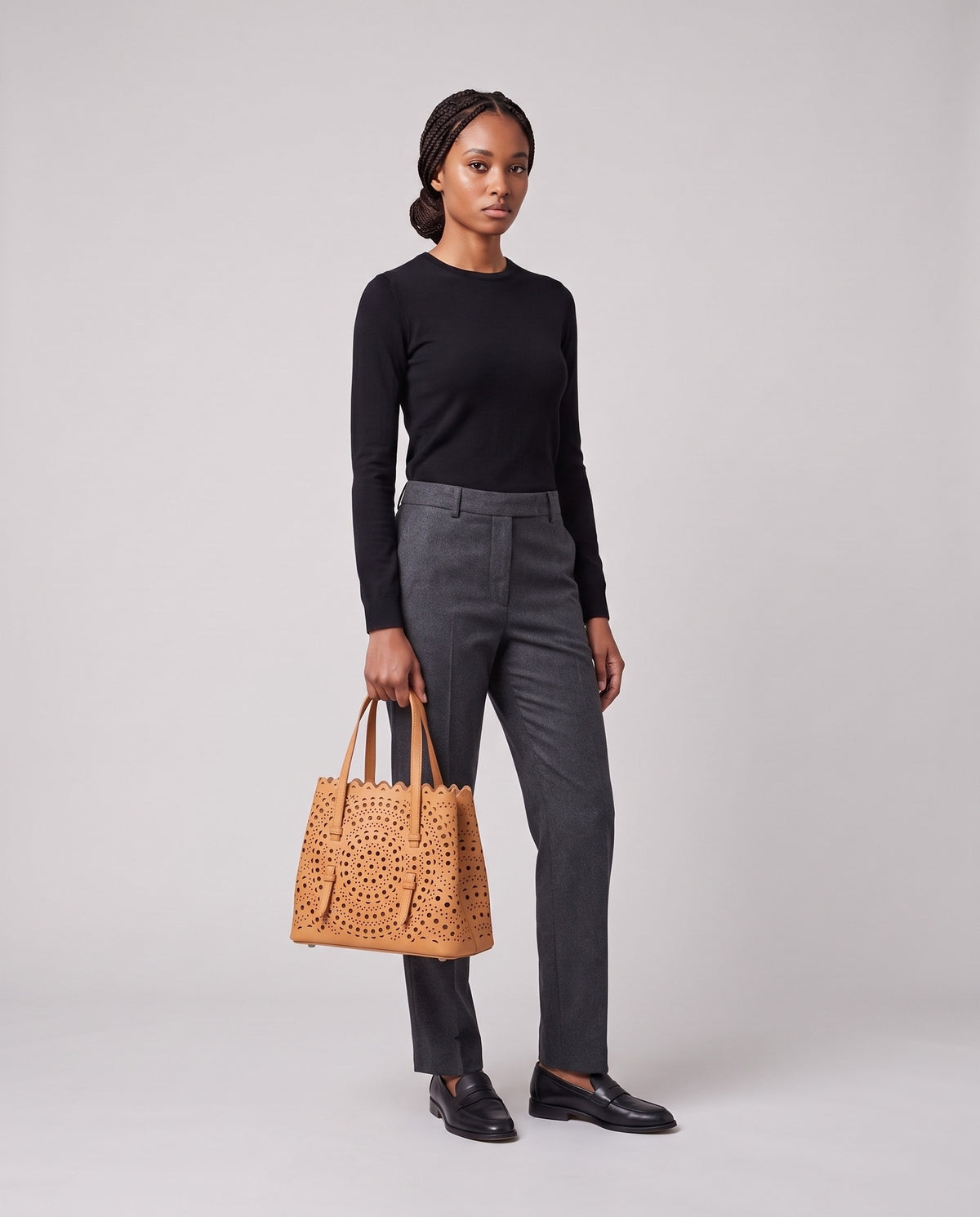 Model holding the Valentina Urbino Medium bag in Apricot, full length