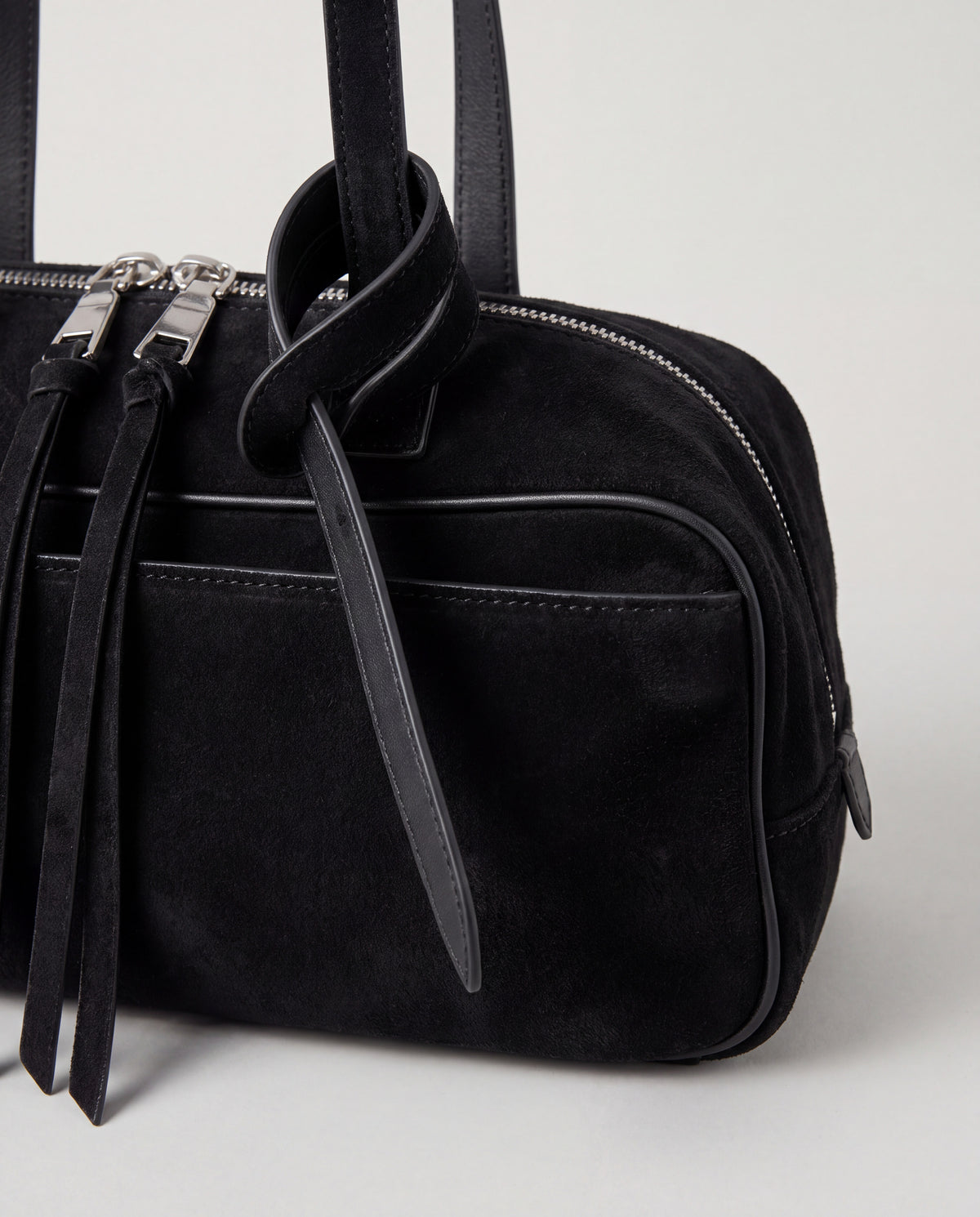 Detail of the knotted strap, double silver zips and suede pulls on the Valentina Linea bag in Black