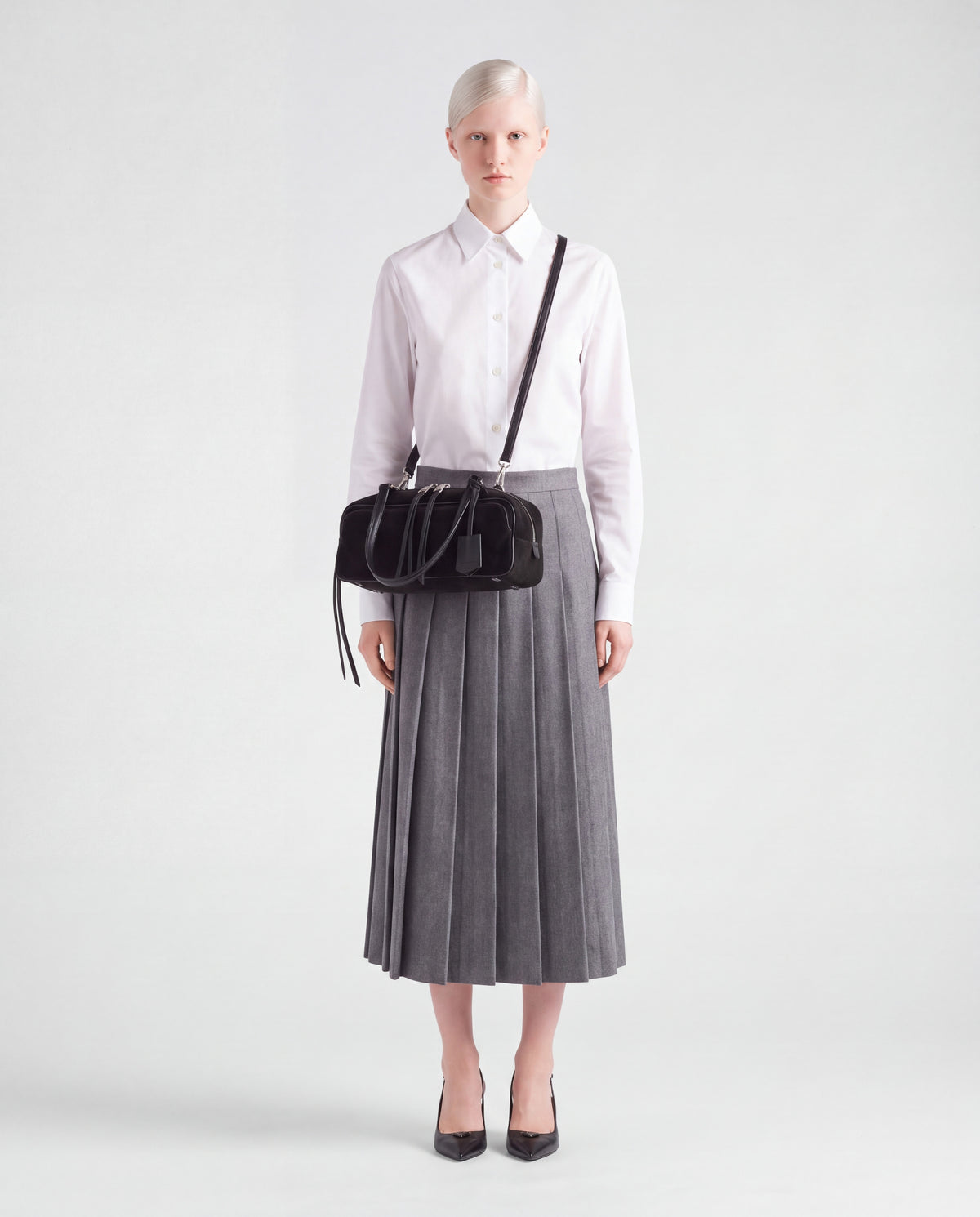 Model wearing the Valentina Linea suede bag in Black crossbody on its long strap