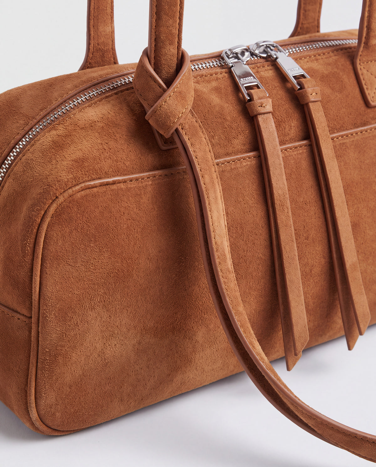Detail of the knotted strap, double silver zips and suede pulls on the Valentina Linea bag in Brown
