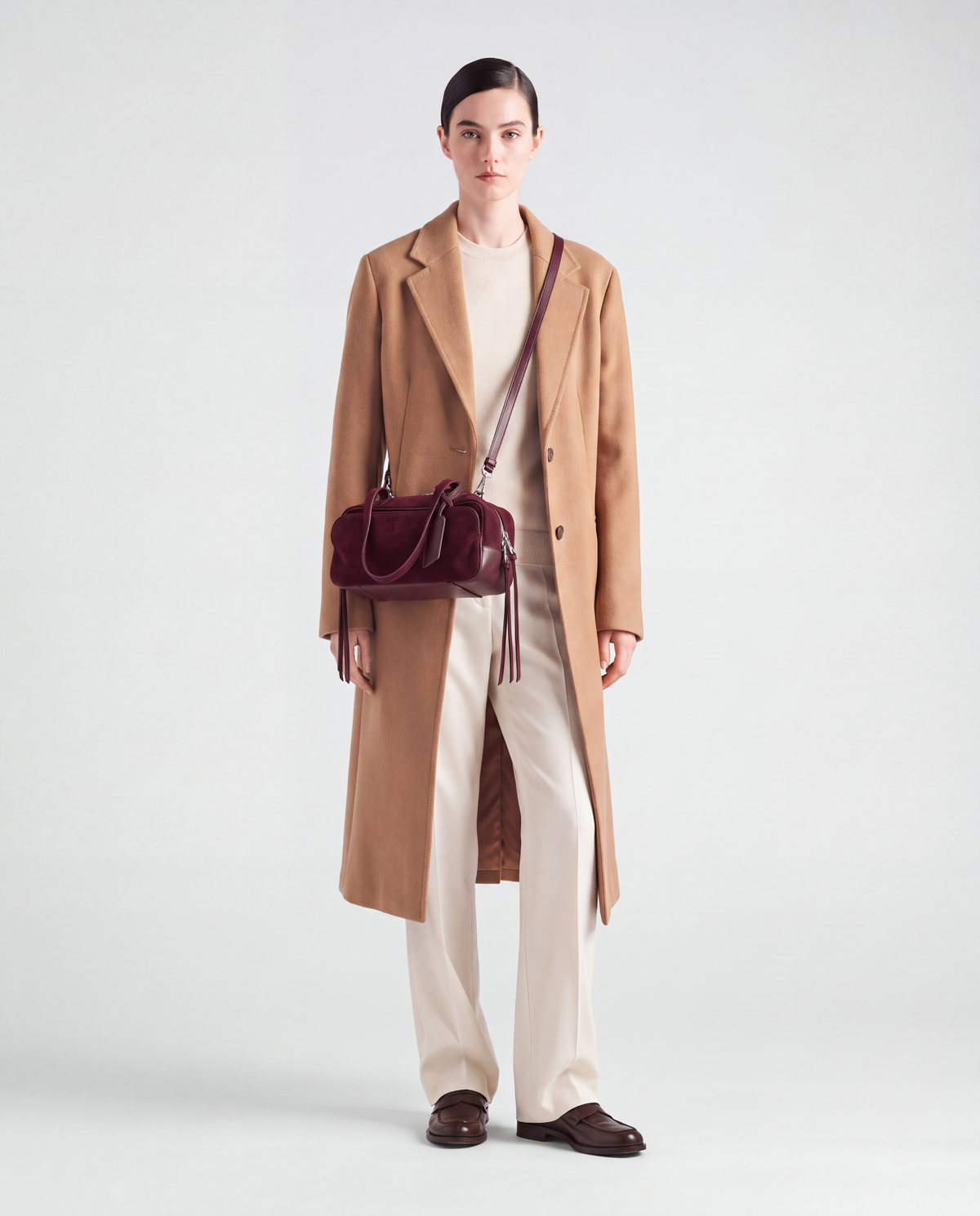 Model wearing the Valentina Linea suede bag in Burgundy crossbody on its long strap