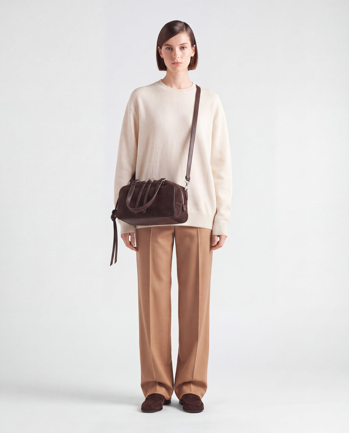 Model wearing the Valentina Linea suede bag in Chocolate crossbody on its long strap