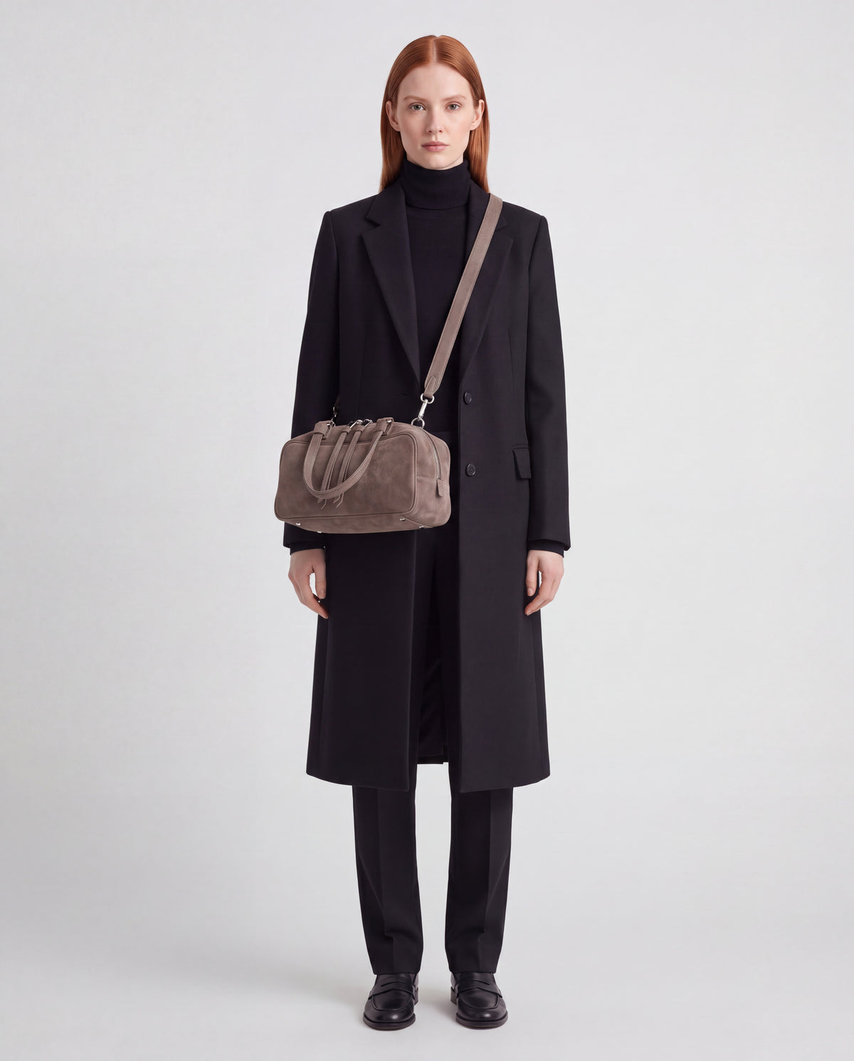 Model wearing the Valentina Linea suede bag in Taupe crossbody on its long strap