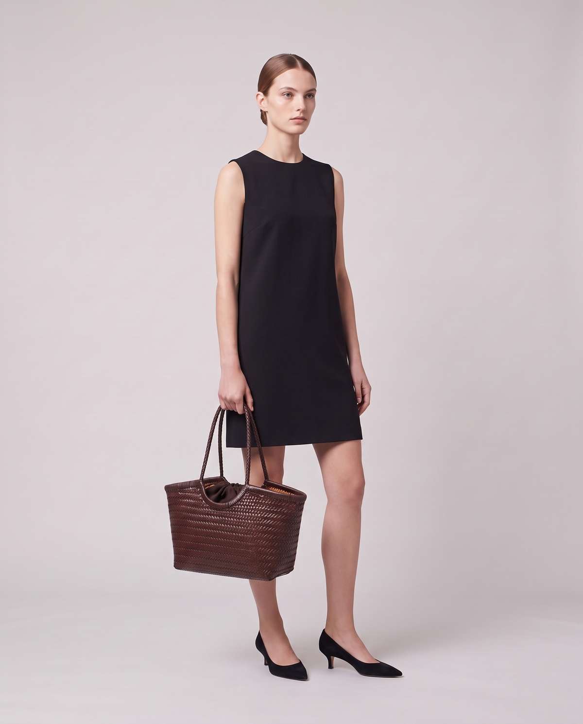 Model holding the Valentina Matera Large bag in Brown, full length