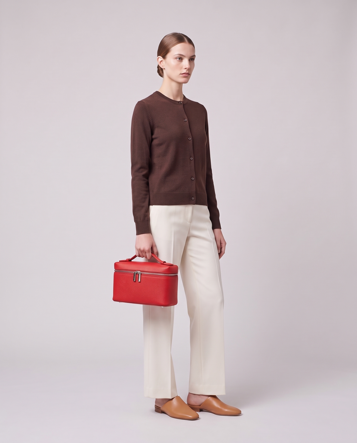 Model carrying the Valentina Orvieto Small top-handle bag in Black leather