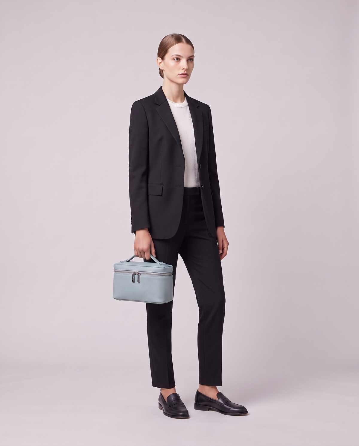 Model holding the Valentina Orvieto Small top-handle bag in Blue leather, full length