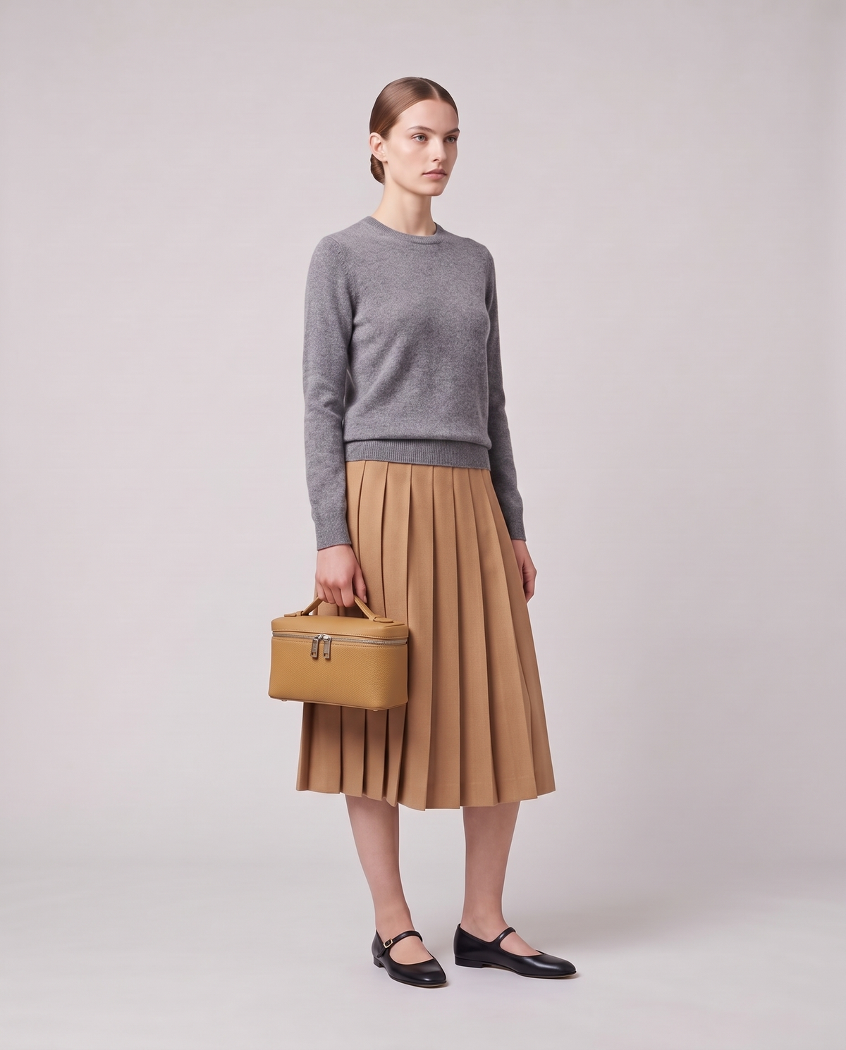 Model carrying the Valentina Orvieto Small top-handle bag in Camel leather