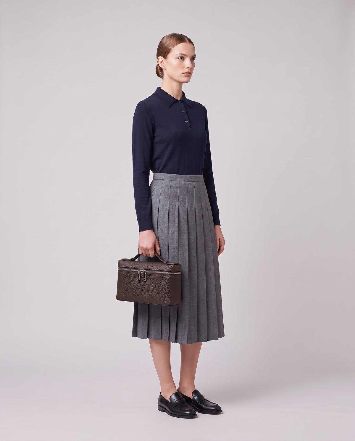 Model holding the Valentina Orvieto Small top-handle bag in Camel leather, full length