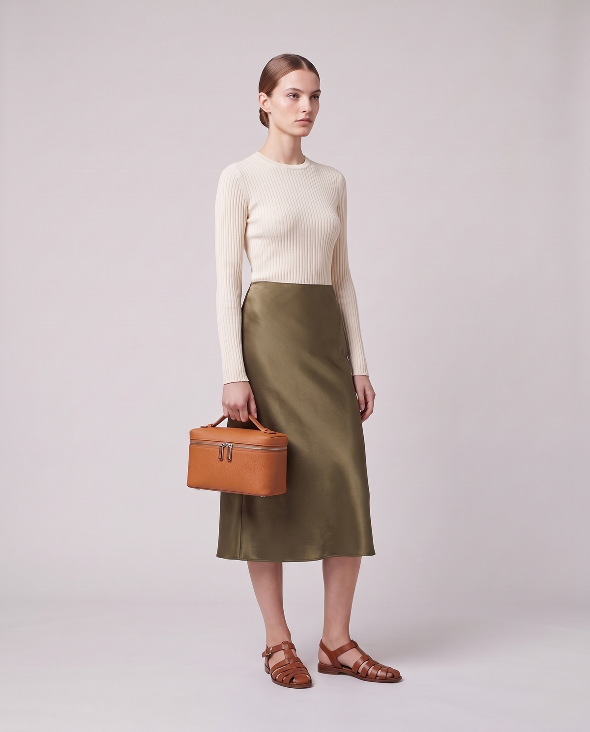Model carrying the Valentina Orvieto Small top-handle bag in Cognac leather