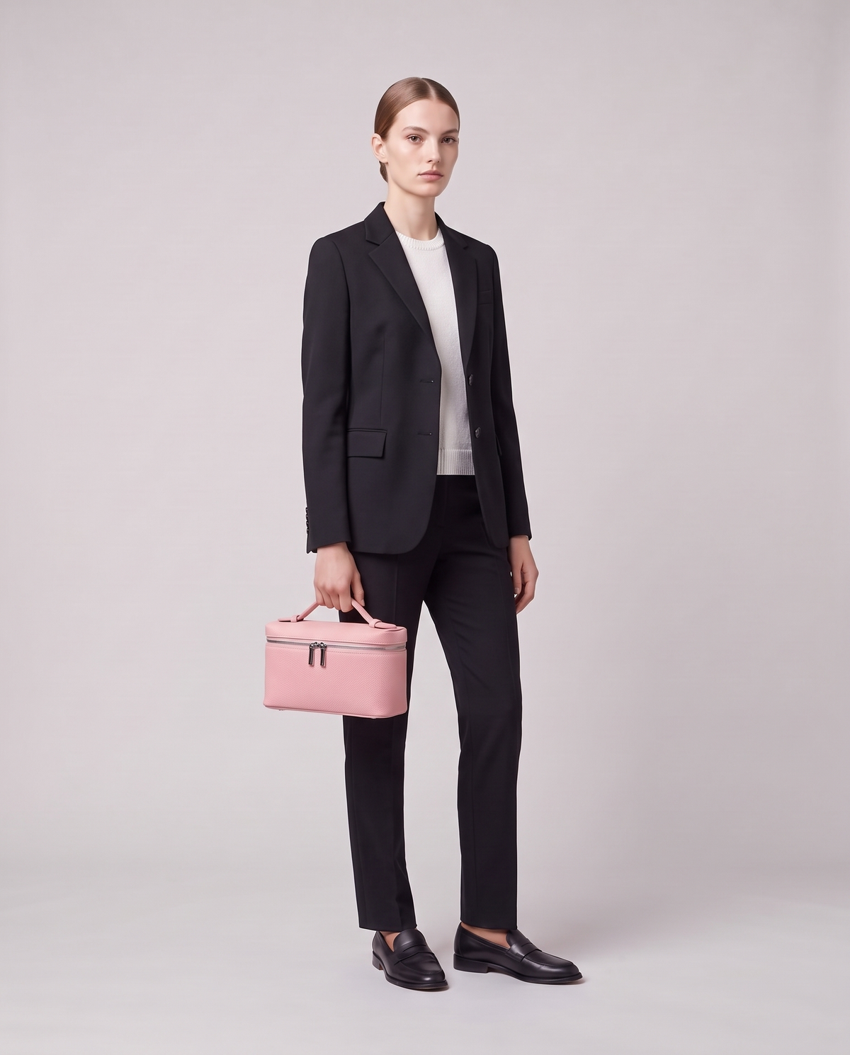 Model carrying the Valentina Orvieto Small top-handle bag in Pink leather