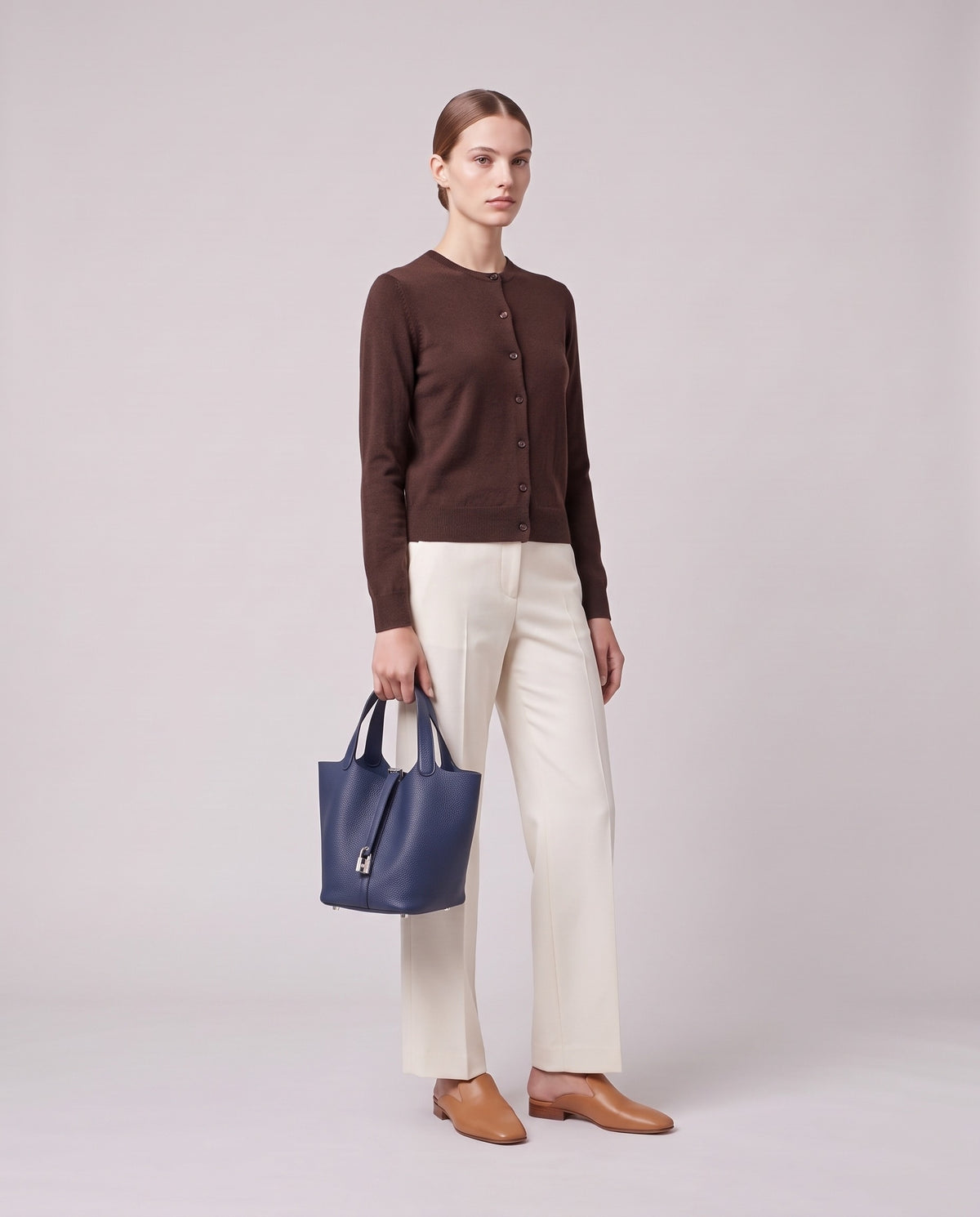 Model holding the Valentina Ostuni Large bag in Navy, full length