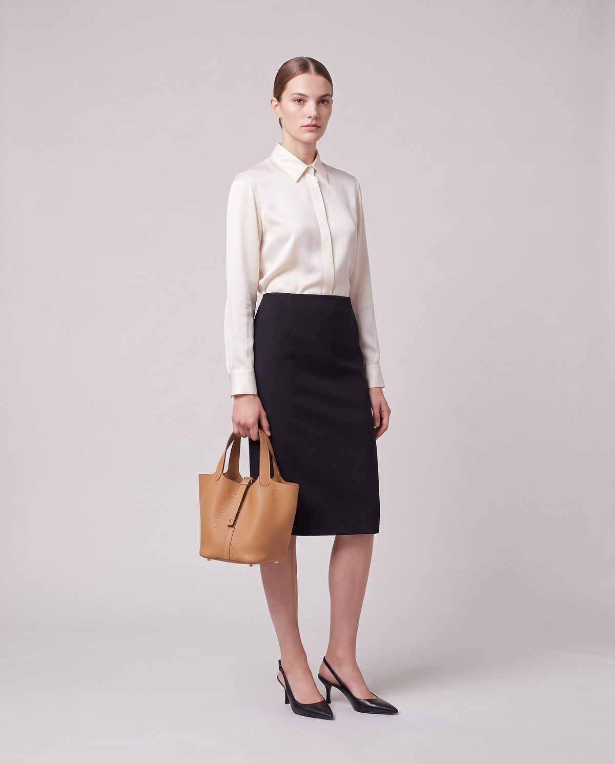 Model holding the Valentina Ostuni Small bag in Tan, full length