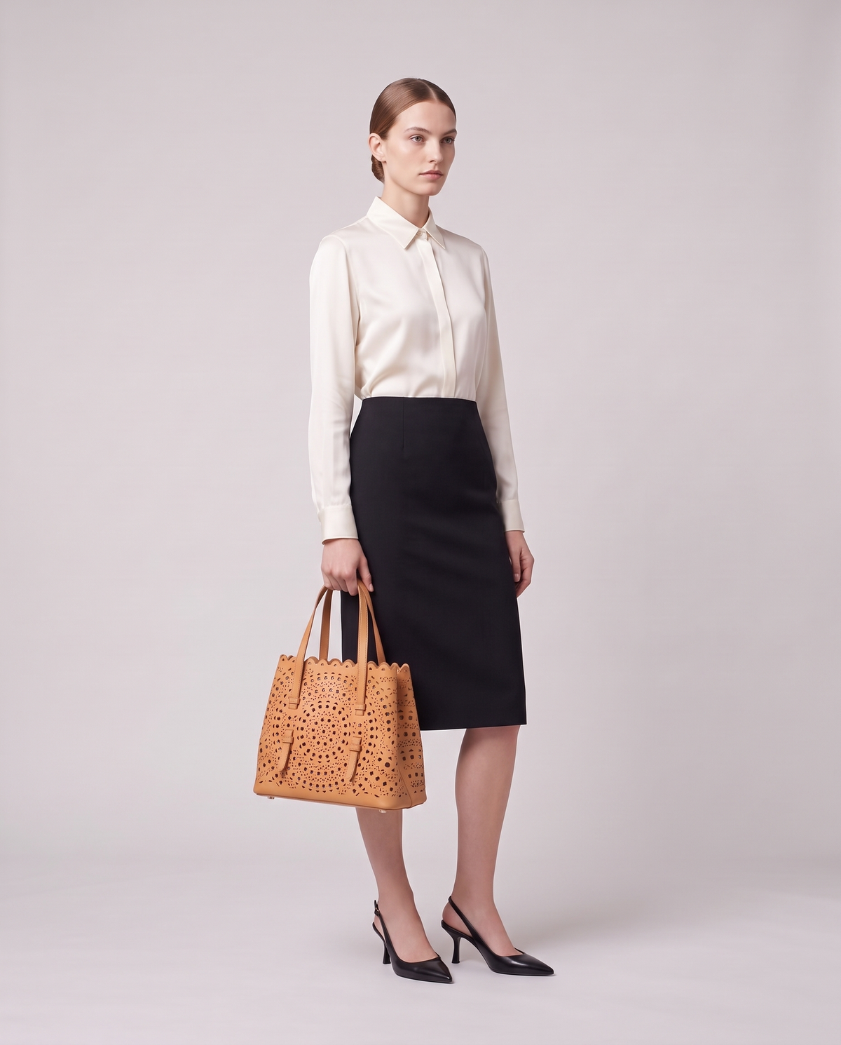Model holding the Valentina Urbino Large bag in Apricot, full length