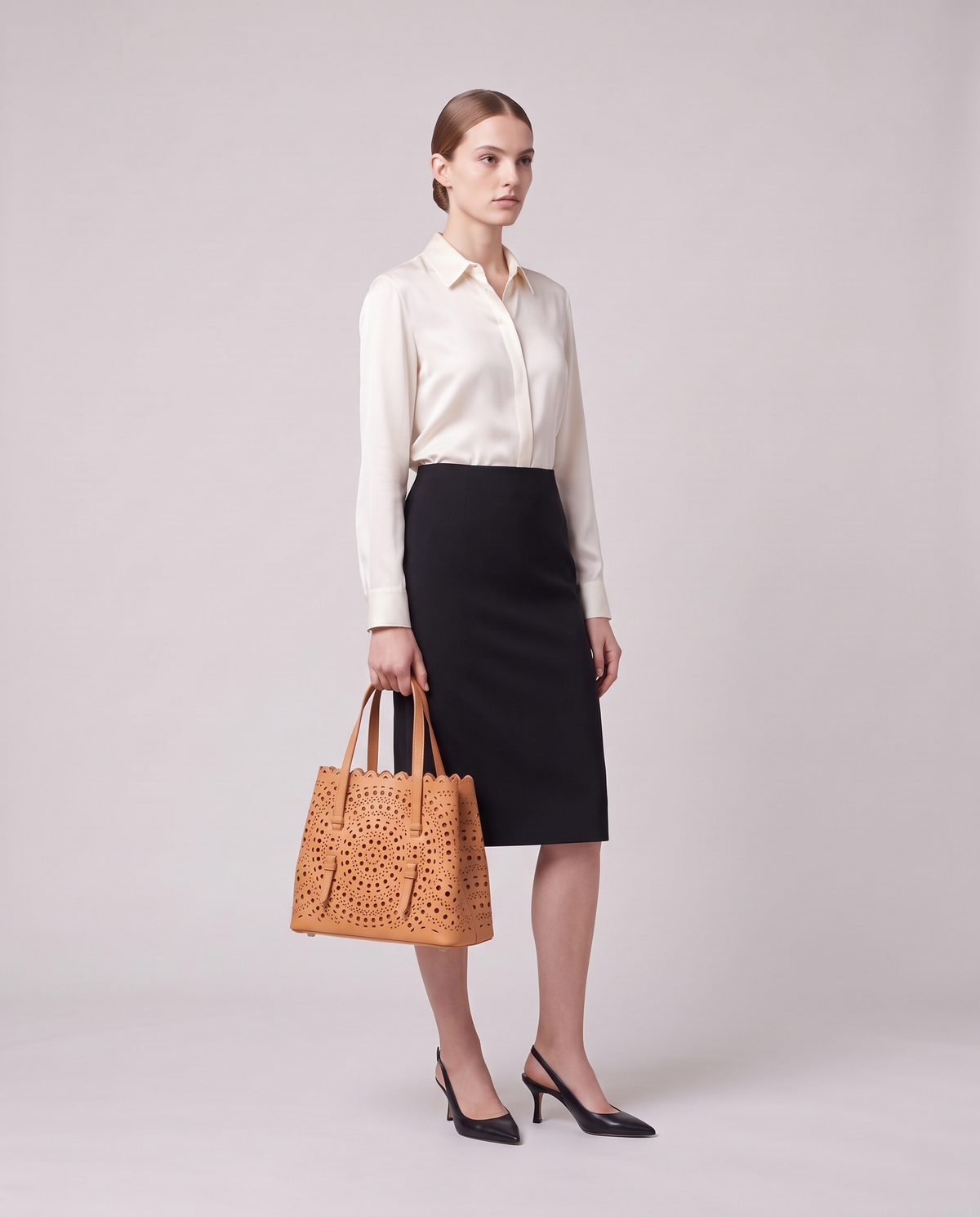 Model carrying the Valentina Urbino Small bag in Apricot