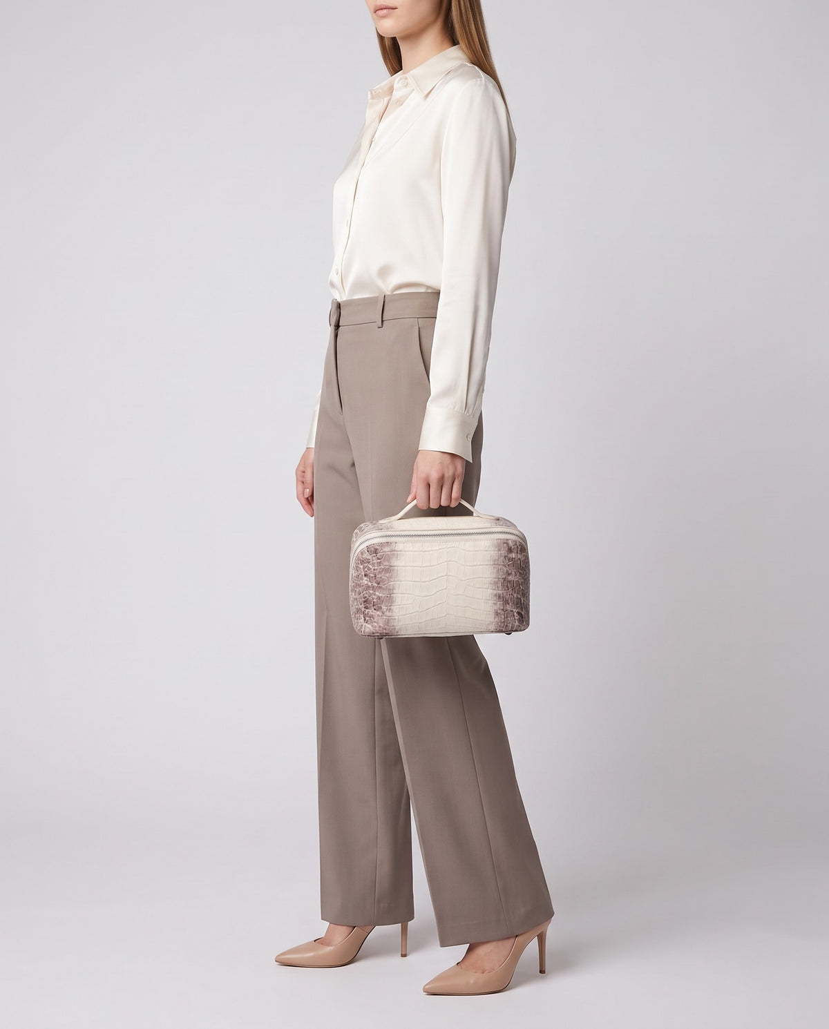 Varenna Large croc-embossed vanity case in Pearl – model carrying it