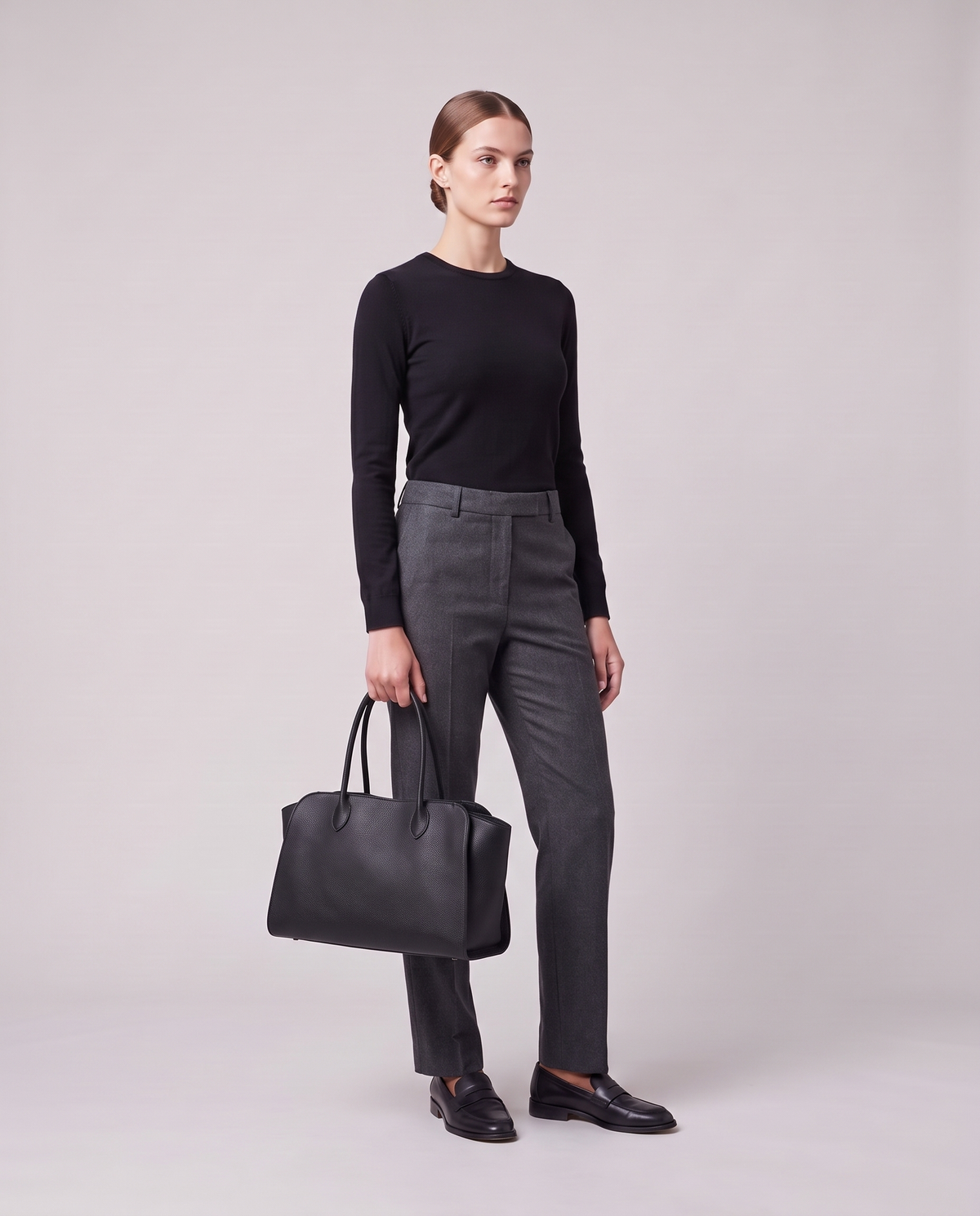 Model holding the Valentina Volta Large bag in Black, full length