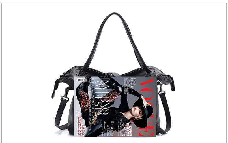 A black leather tote bag with a magazine