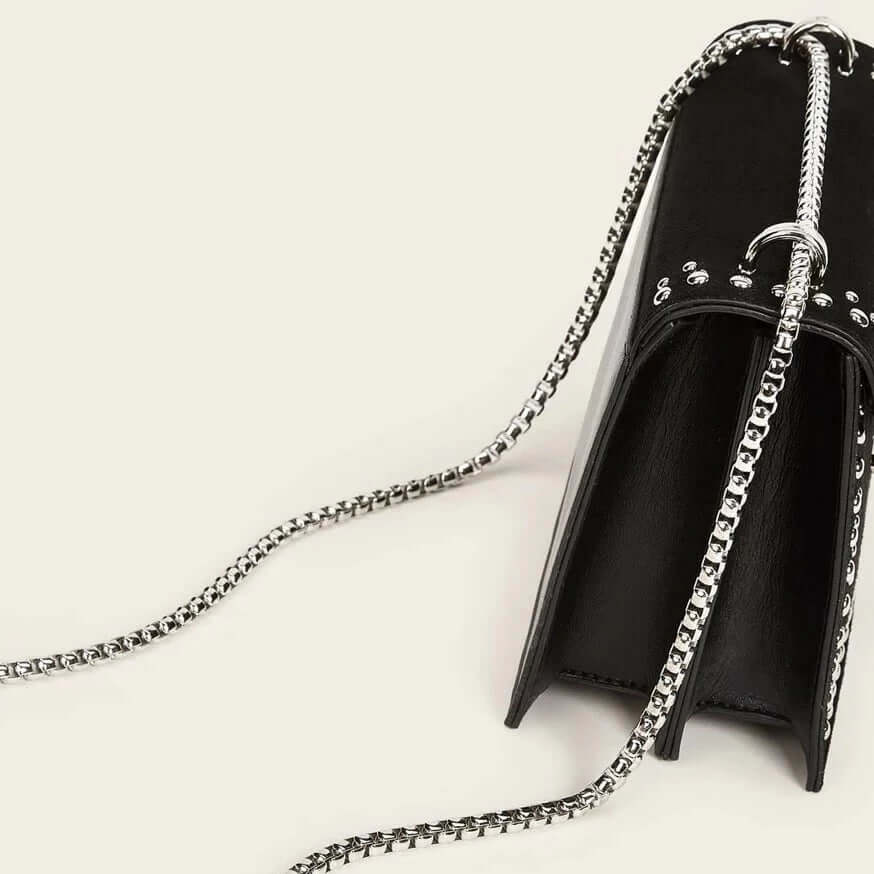 A black studded vegan leather bag