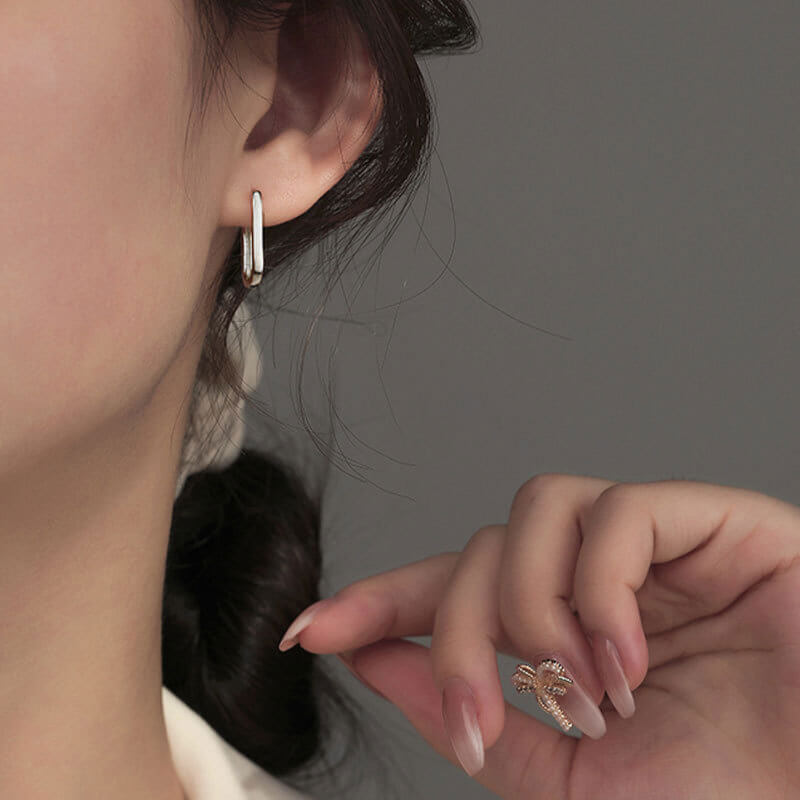 Model wearing silver Big Paperclip Earrings