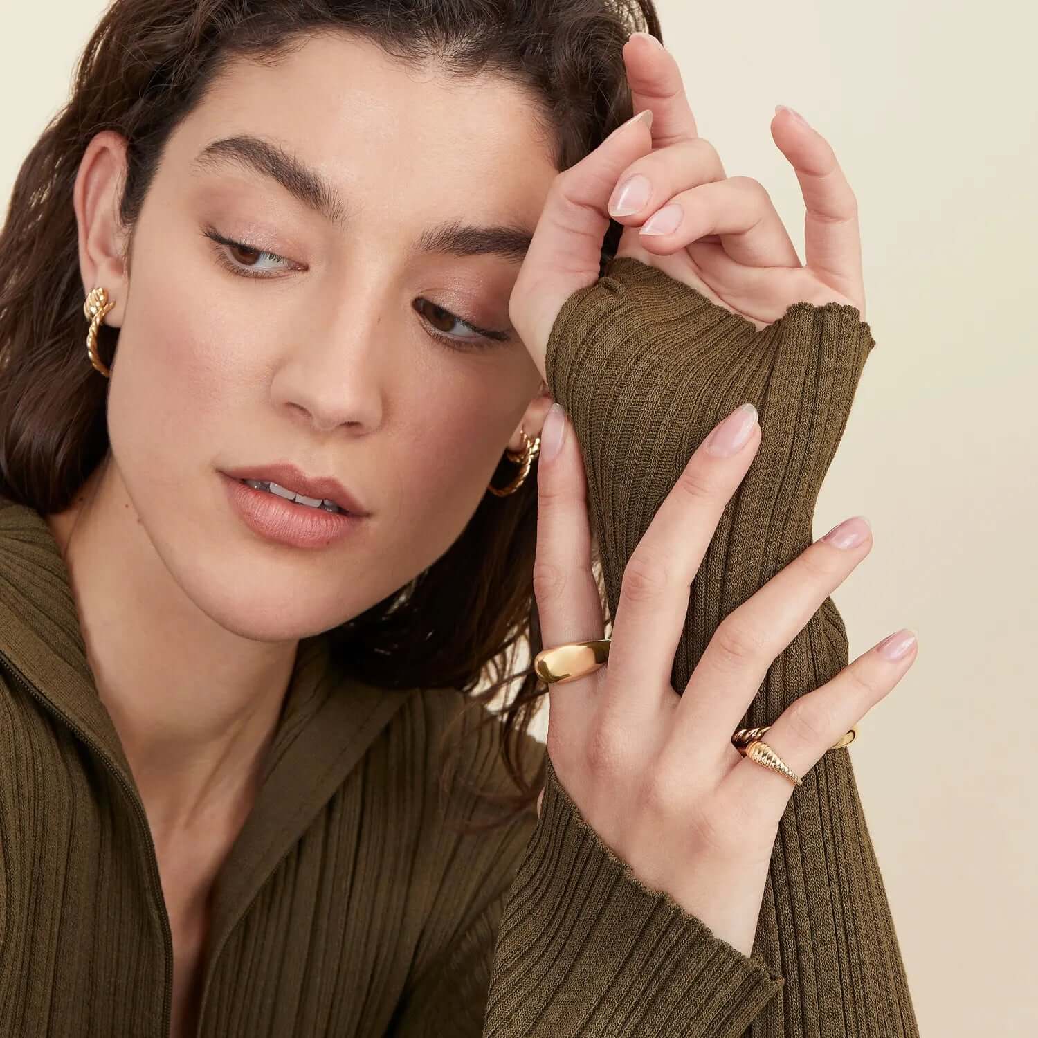 A model wearing gold jewelry