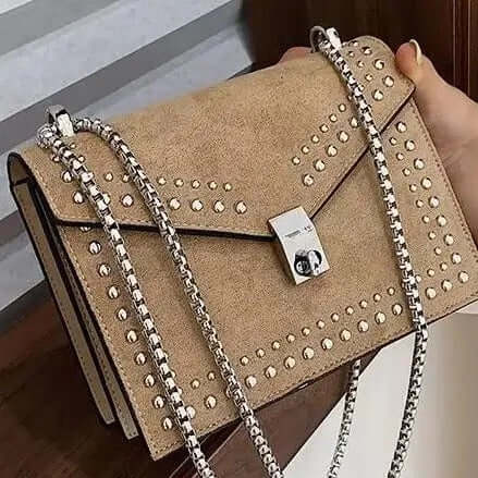 A beige studded vegan leather bag