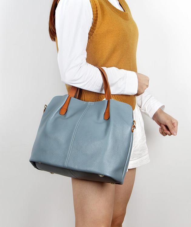 Model carrying Blue Leather Tote Bag