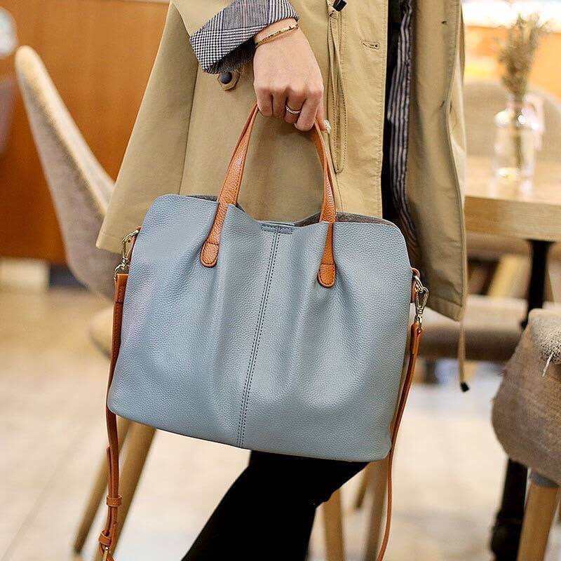 Model carrying blue Leather Tote Bag