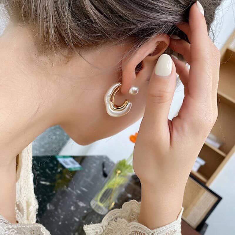 Model wearing White Distorted Pearl Hoop Earrings