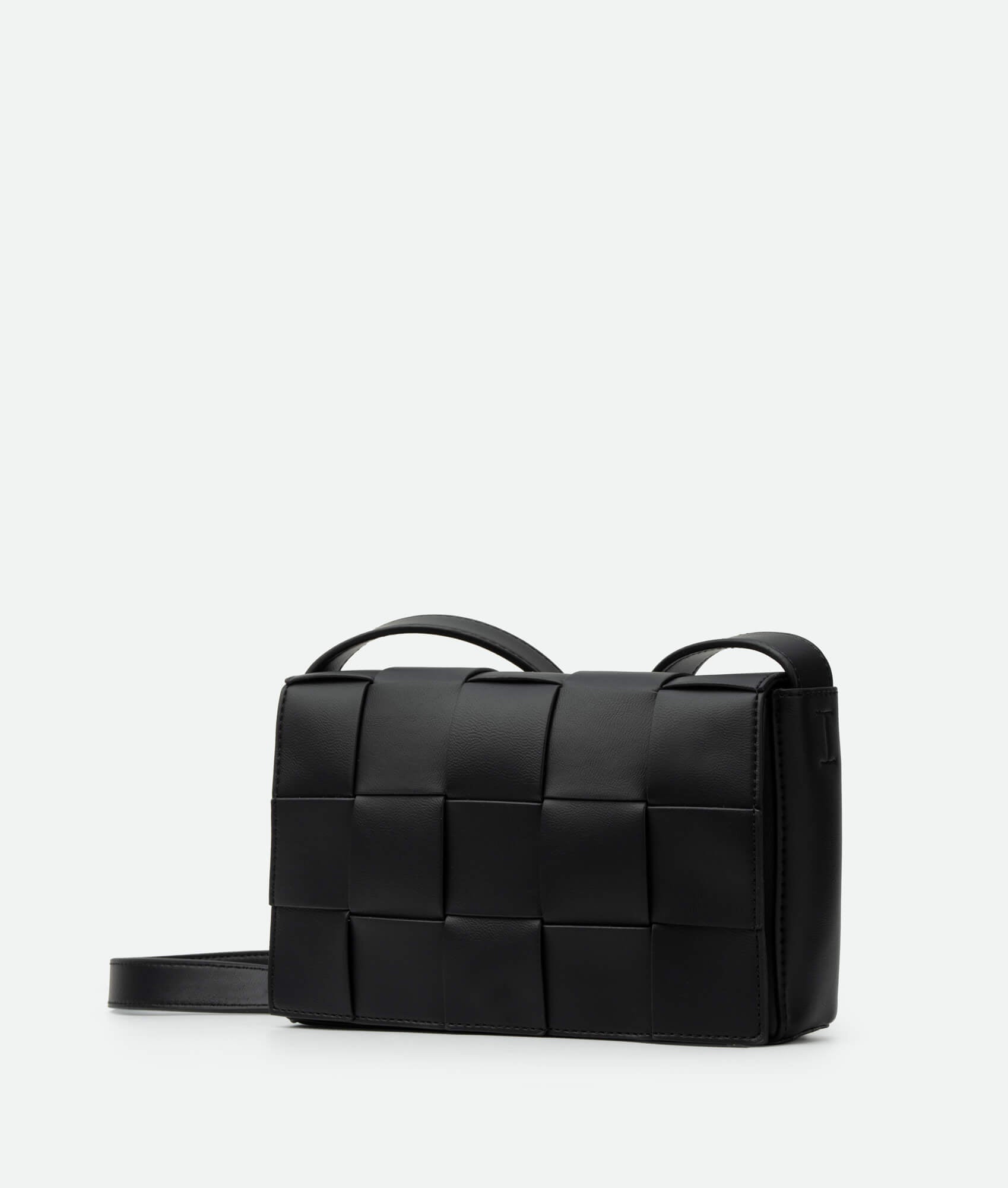 A black woven crossbody bag with a structured design and a shoulder strap.