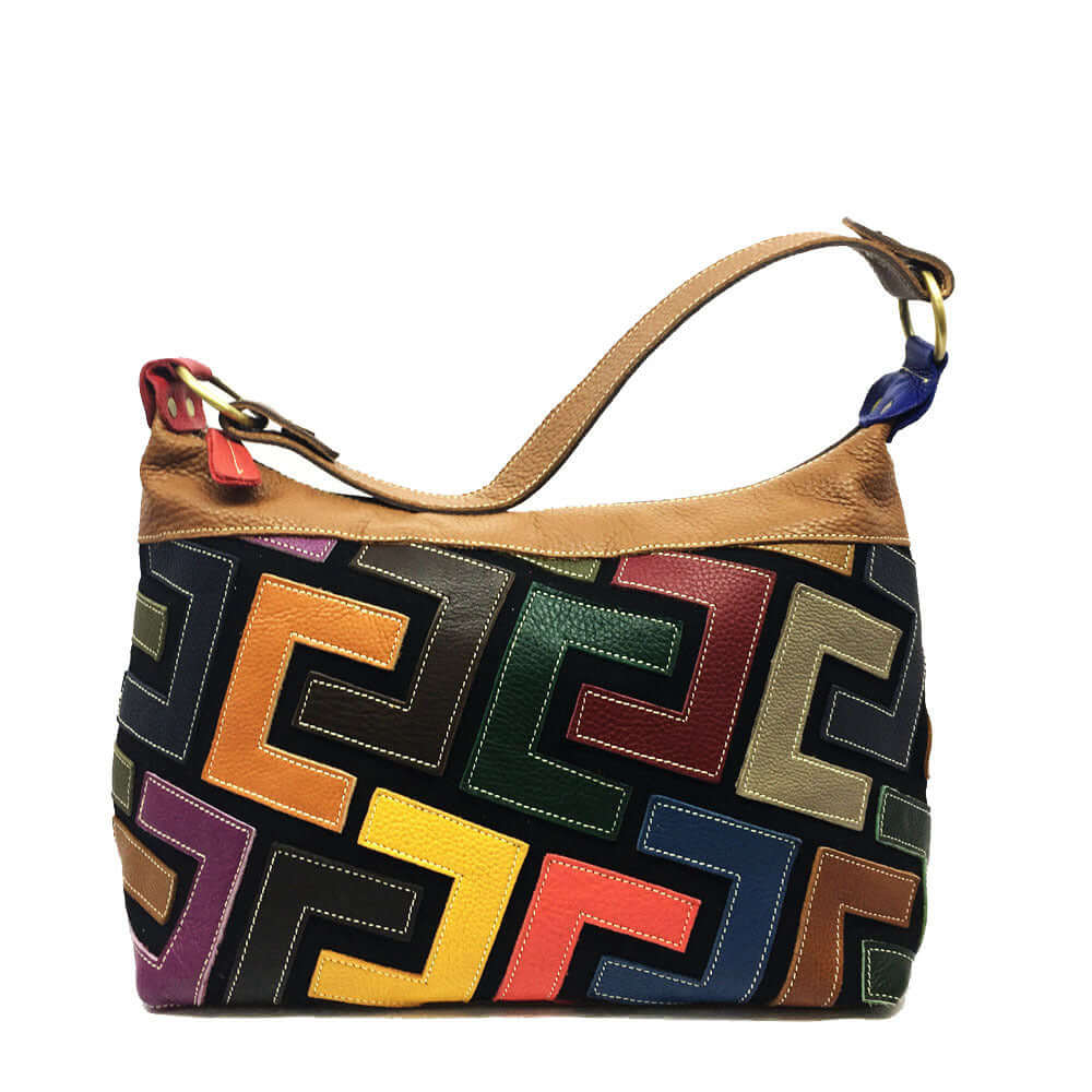 A colorful geometric patterned shoulder bag with a tan leather finish and a red wristlet strap.