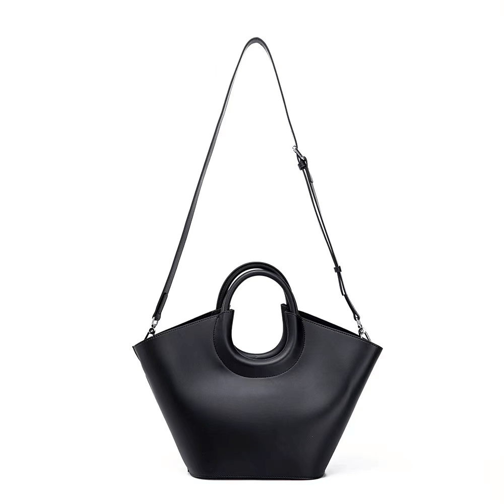 Black handbag with a shoulder strap on a white background