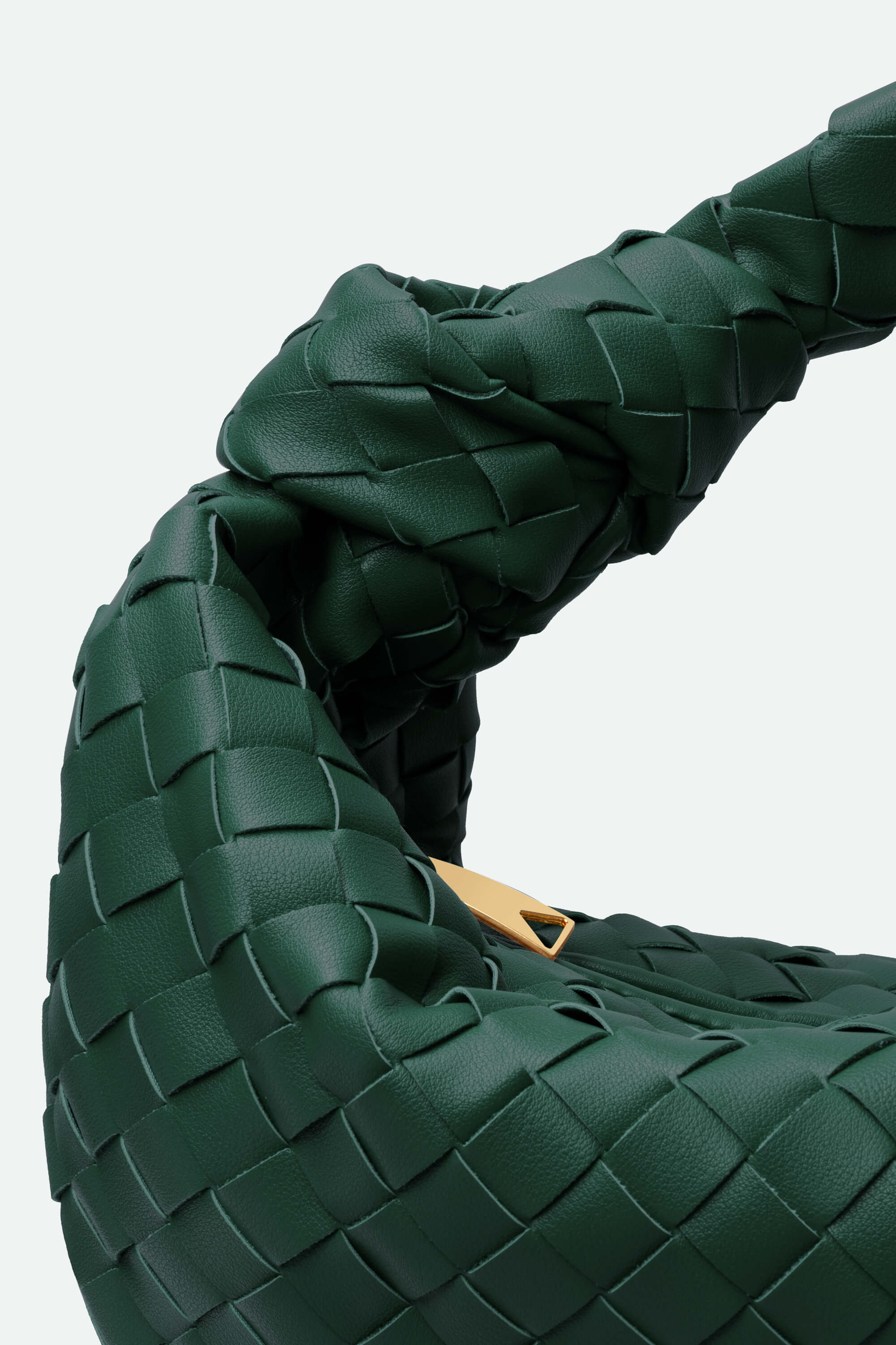 Close-up of a green woven handbag with a gold clasp on a light gray background