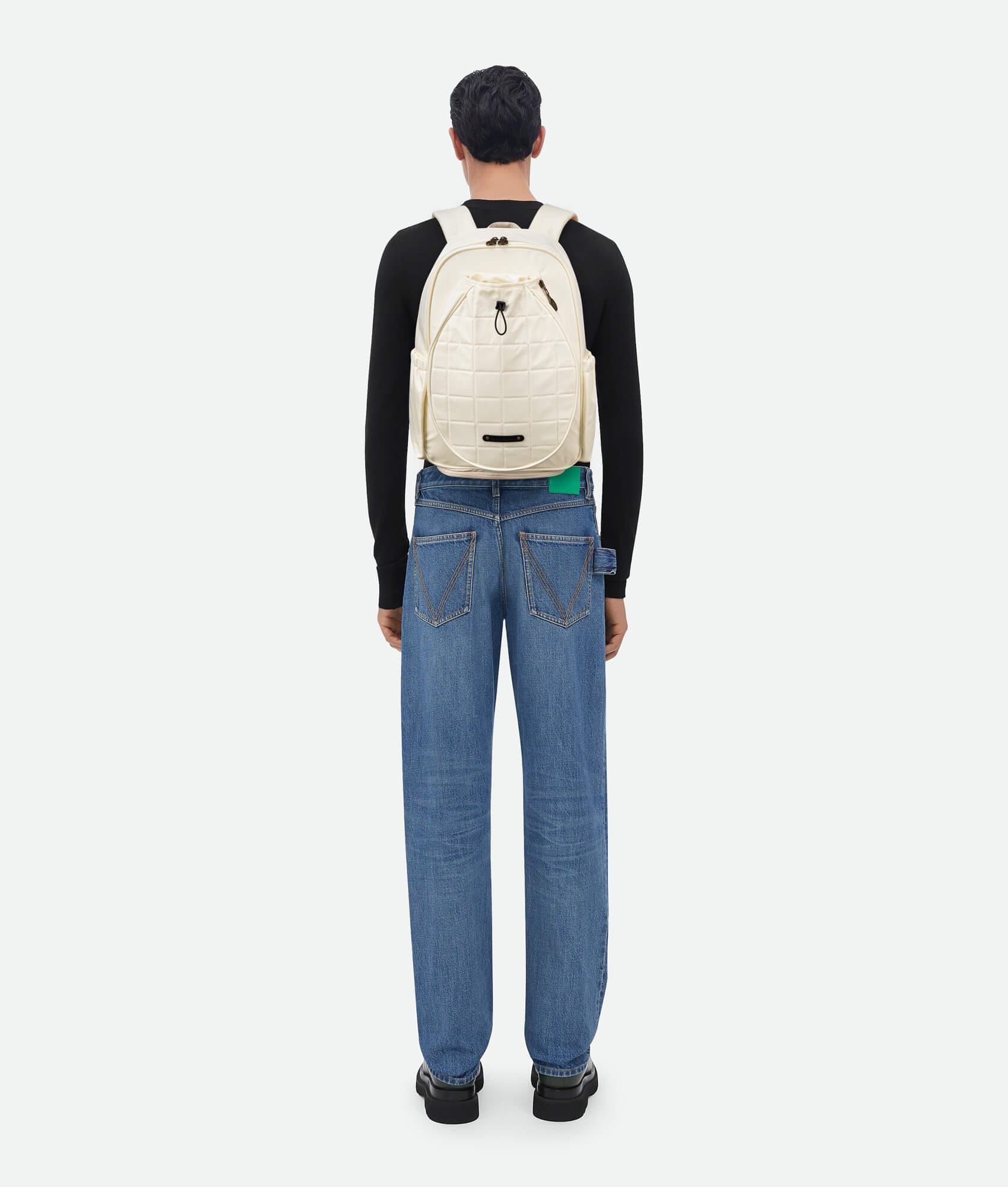 Man wearing white Tennis Backpack