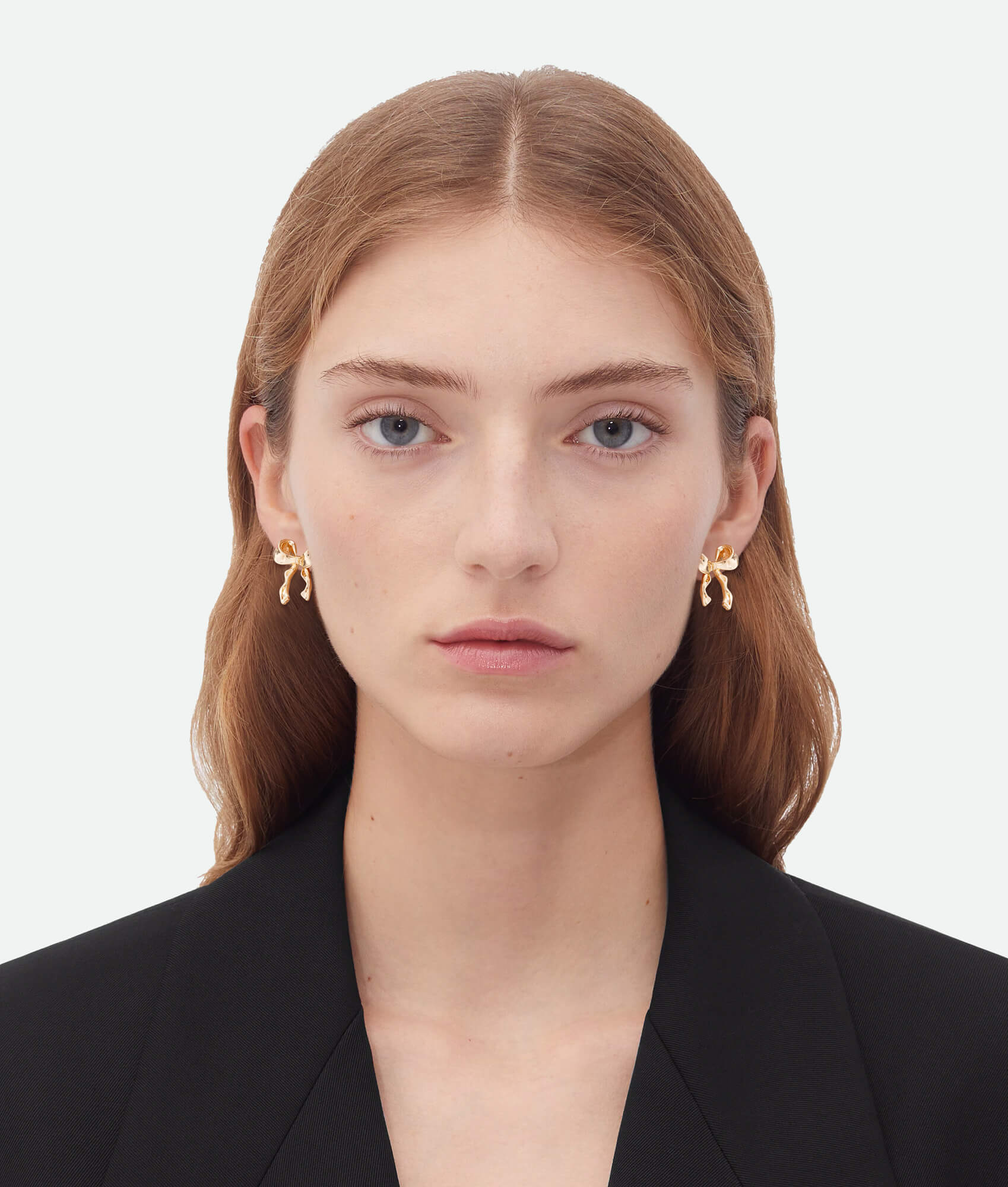 Model wearing Gold bow earrings