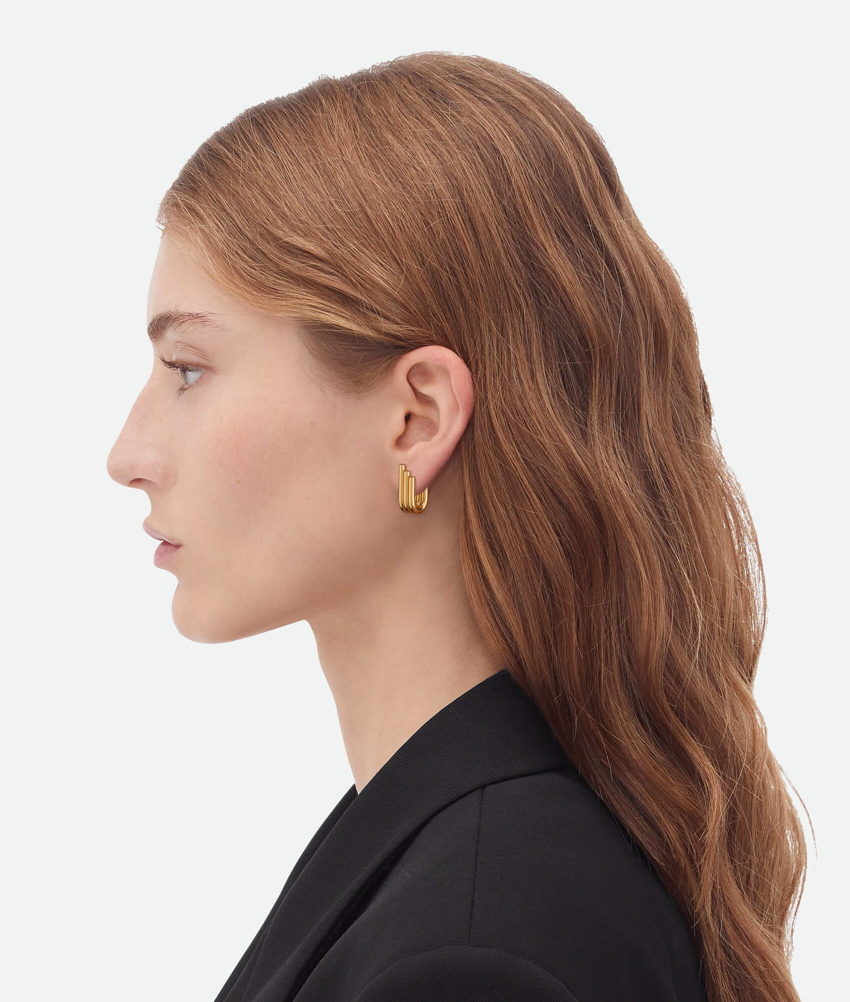 Model wearing Gold wing earrings