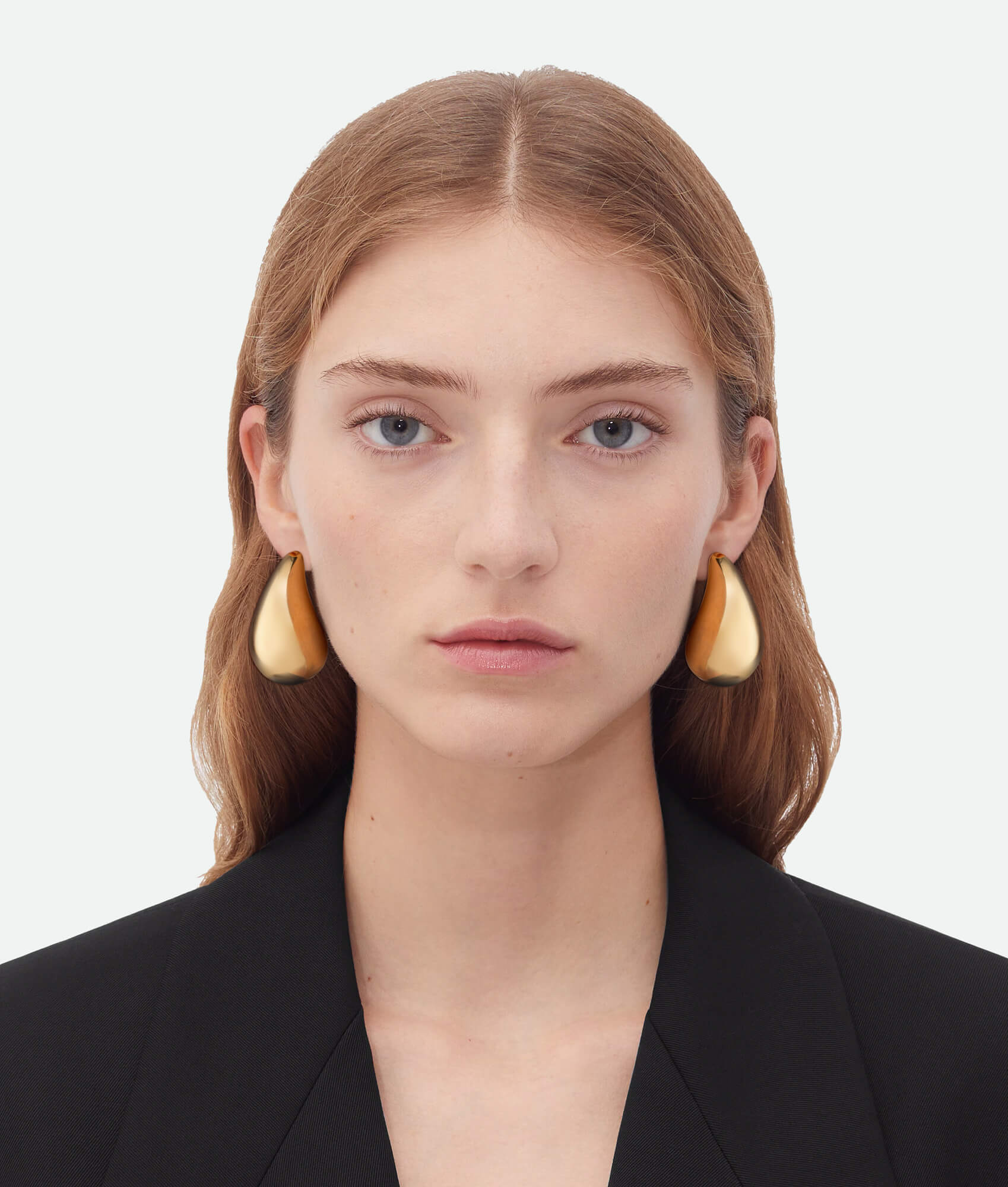 Model wearing Bottega drop earrings gold