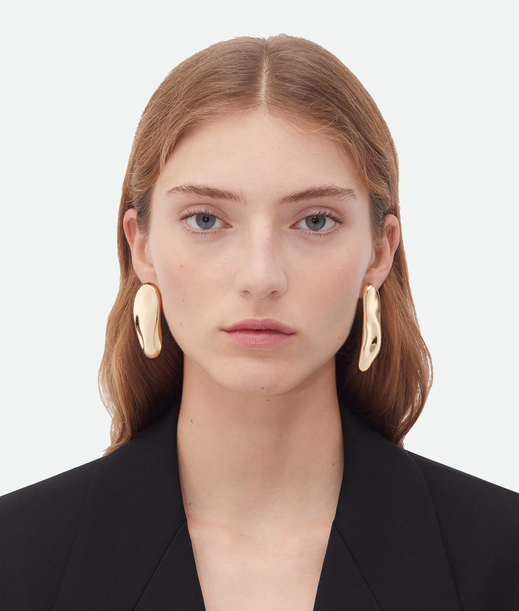 Model wearing French asymmetrical earrings