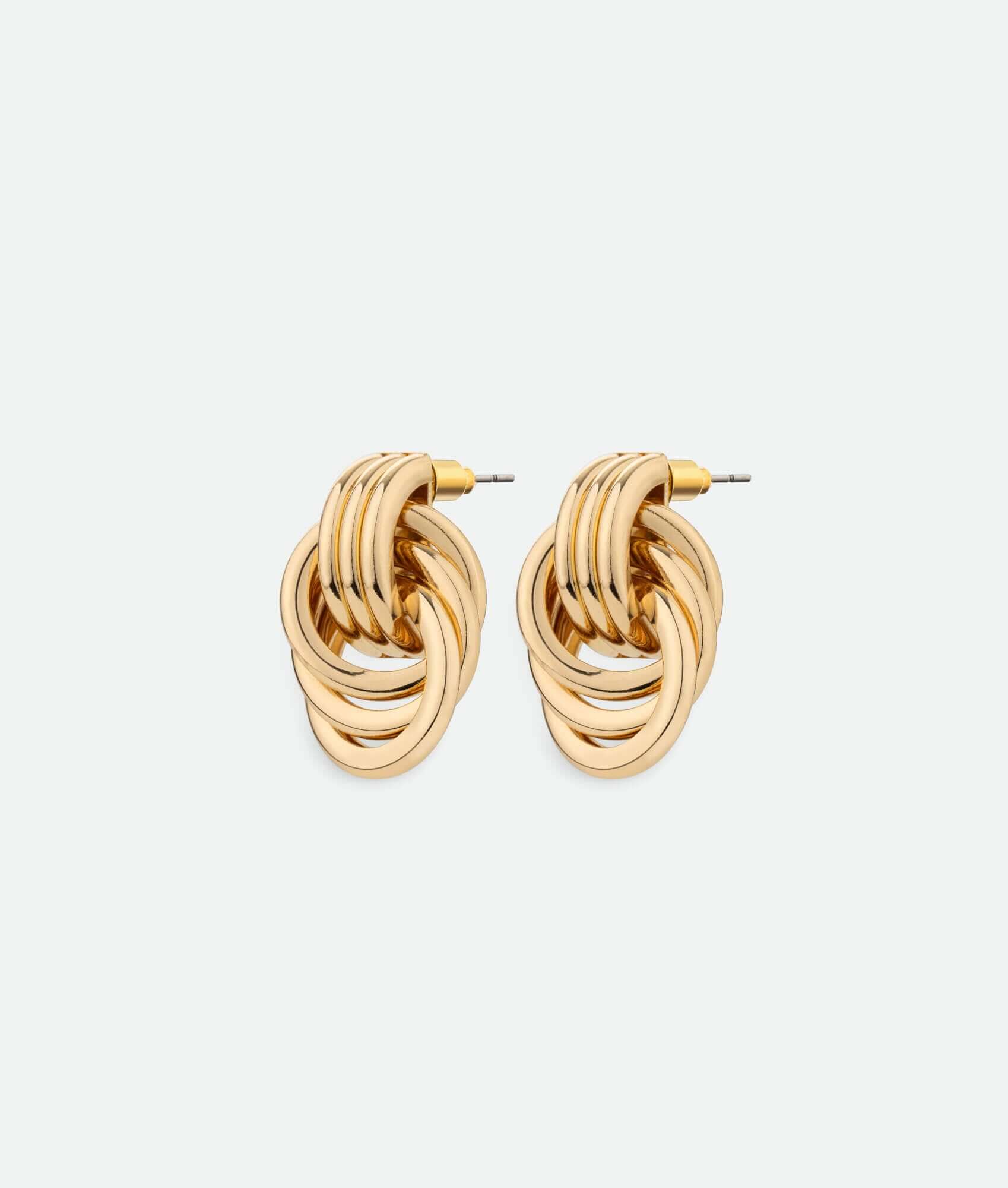 A pair of gold knot earrings