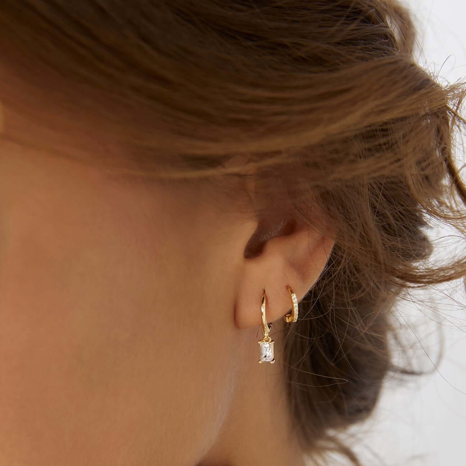 A woman showing her stack earrings