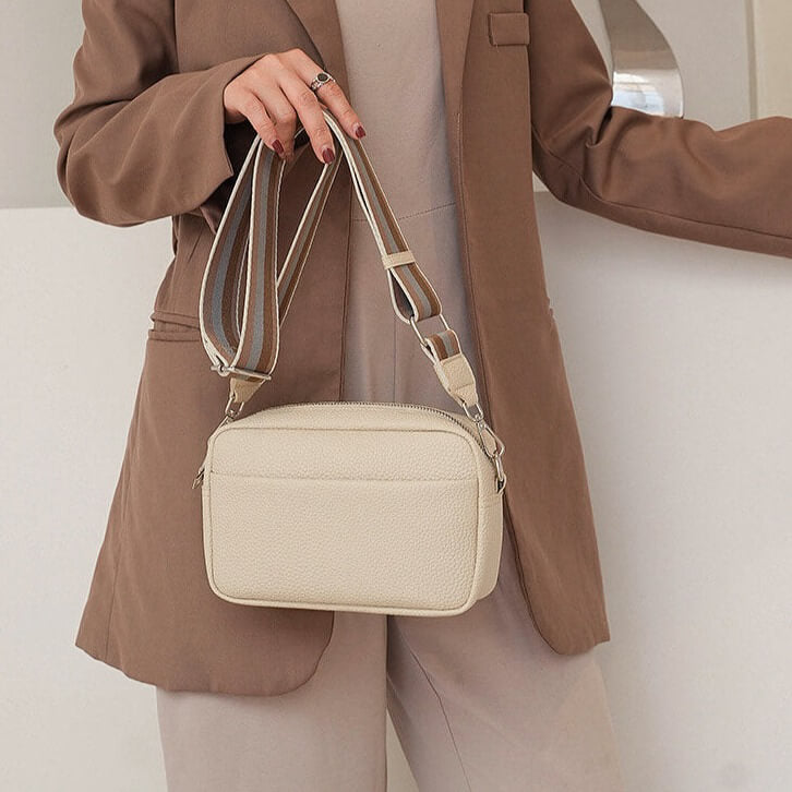 Woman carrying a Wide Strap Crossbody Bag bleige