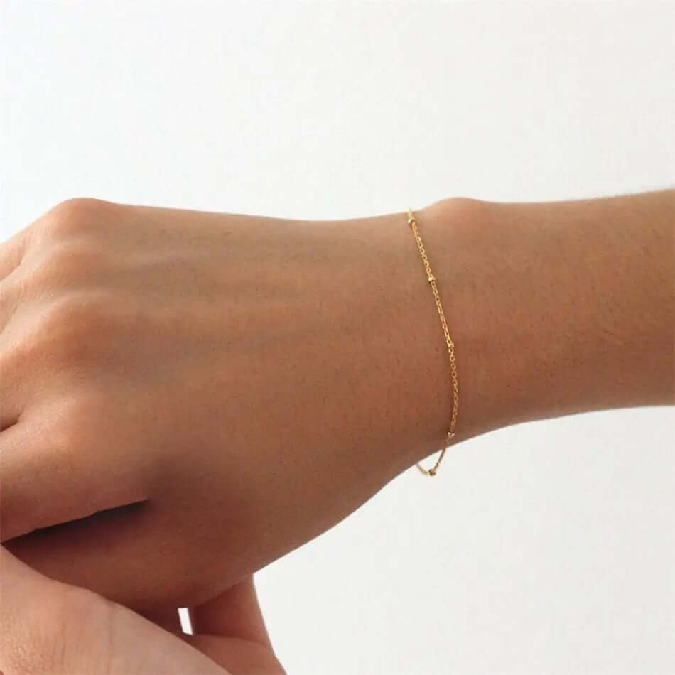 A model wearing gold chain bracelet