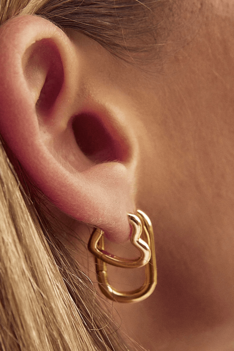 Model wearing Heart hoop earrings gold