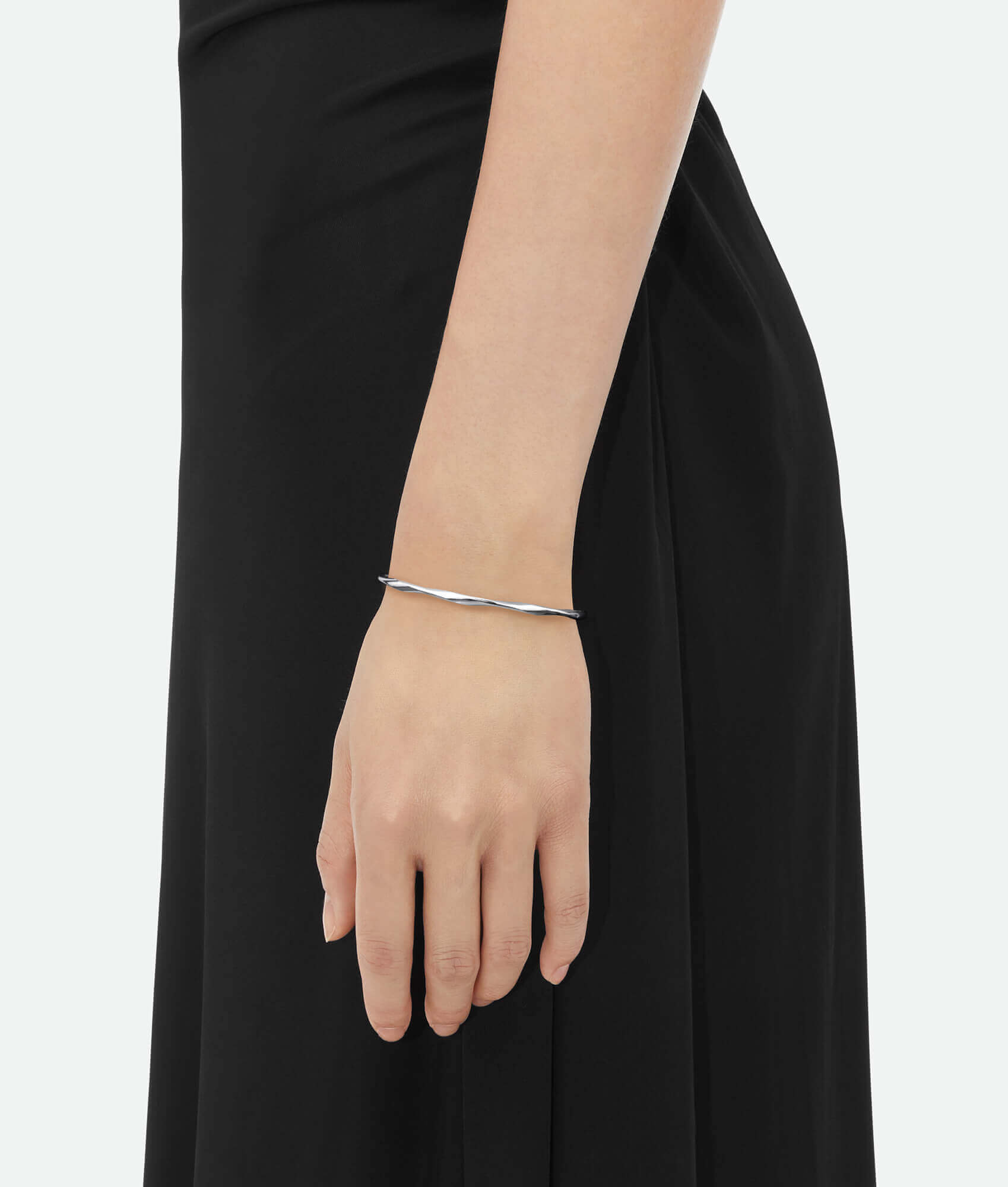 A model wearing a silver cuff bracelet