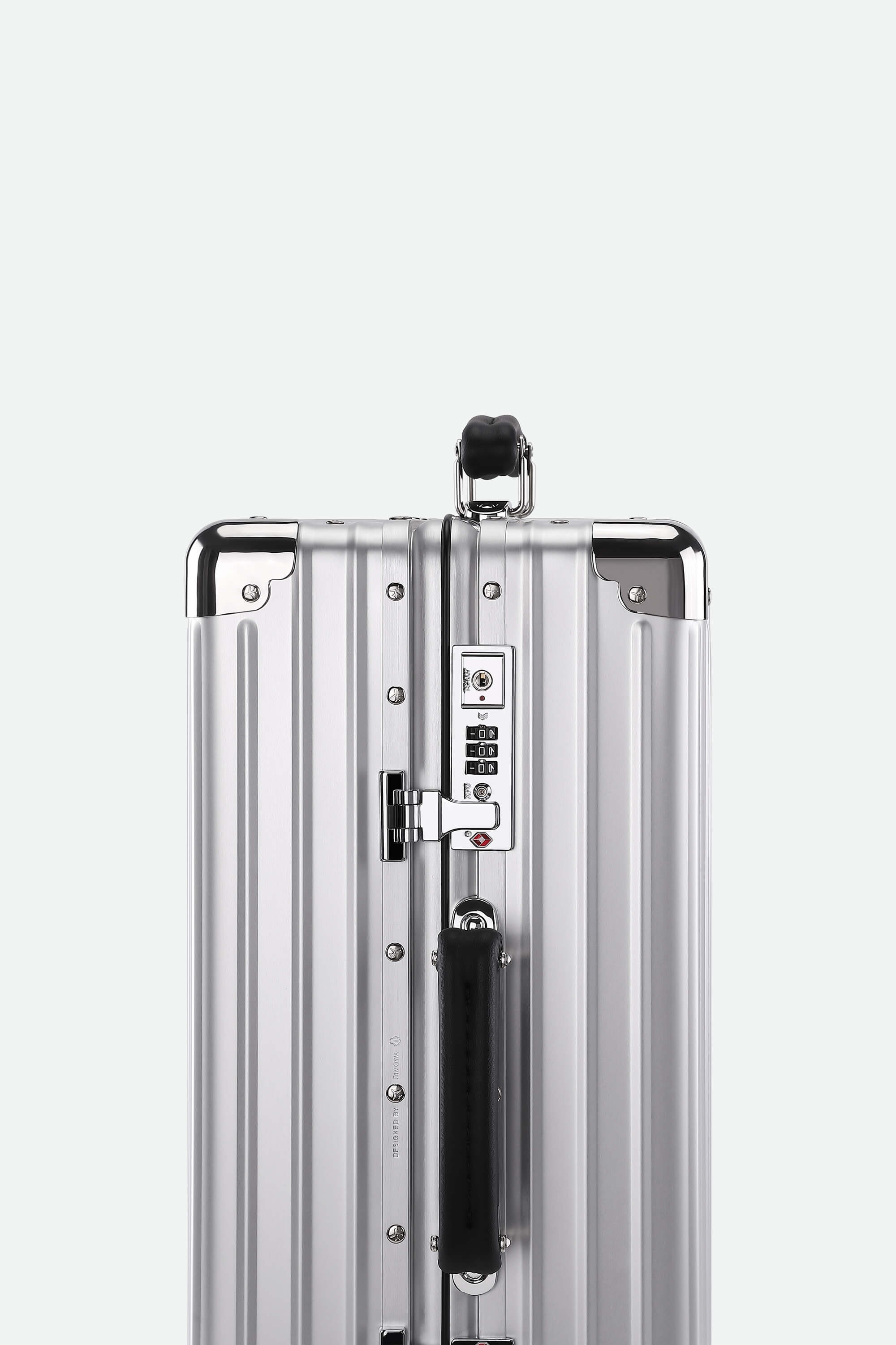 Silver suitcase with a black handle on a white background